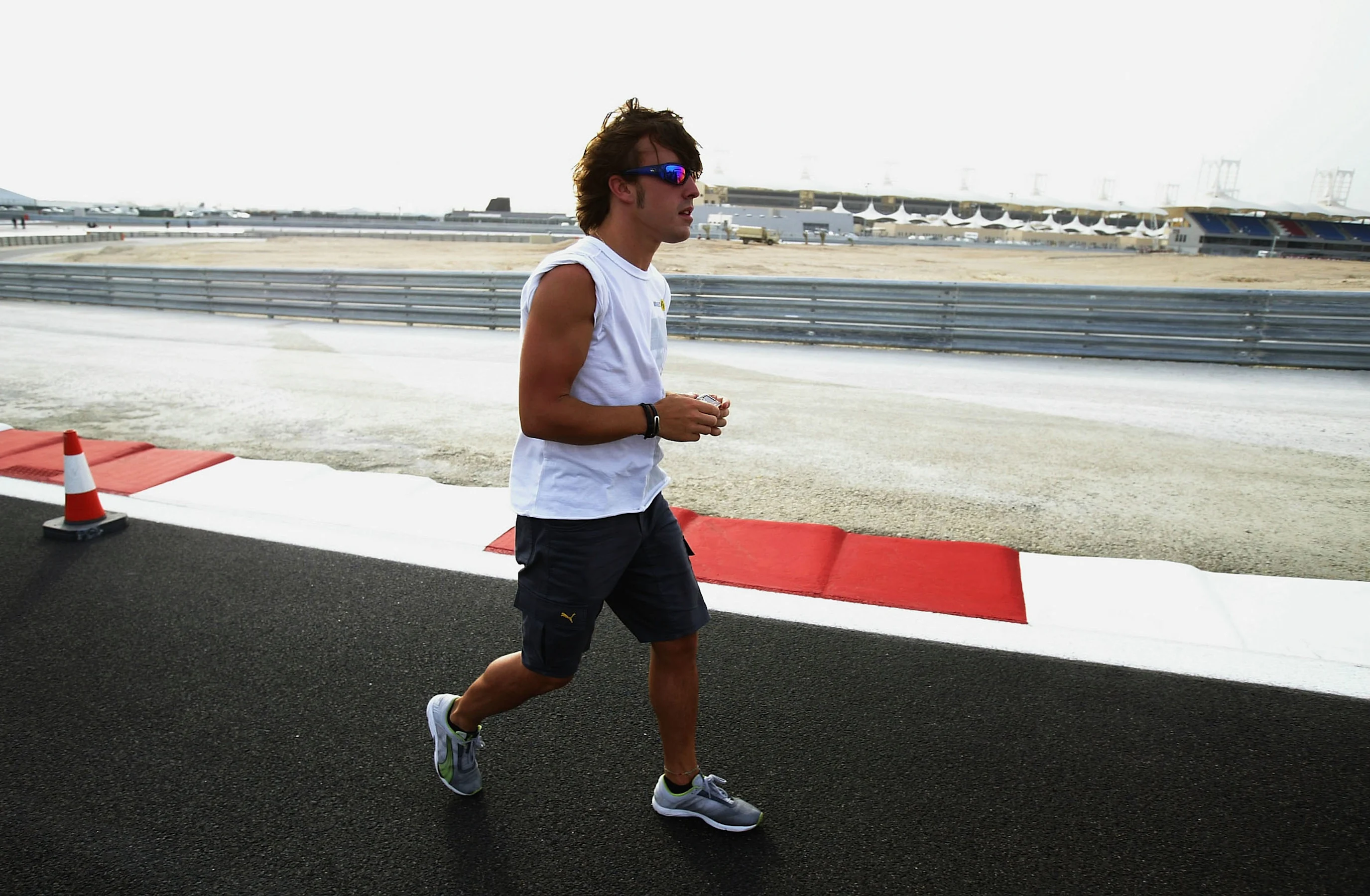 SAKHIR, BAHRAIN - MARCH 31:  Fernando Alonso of Spain and Renault walks the new cuicuit prior to