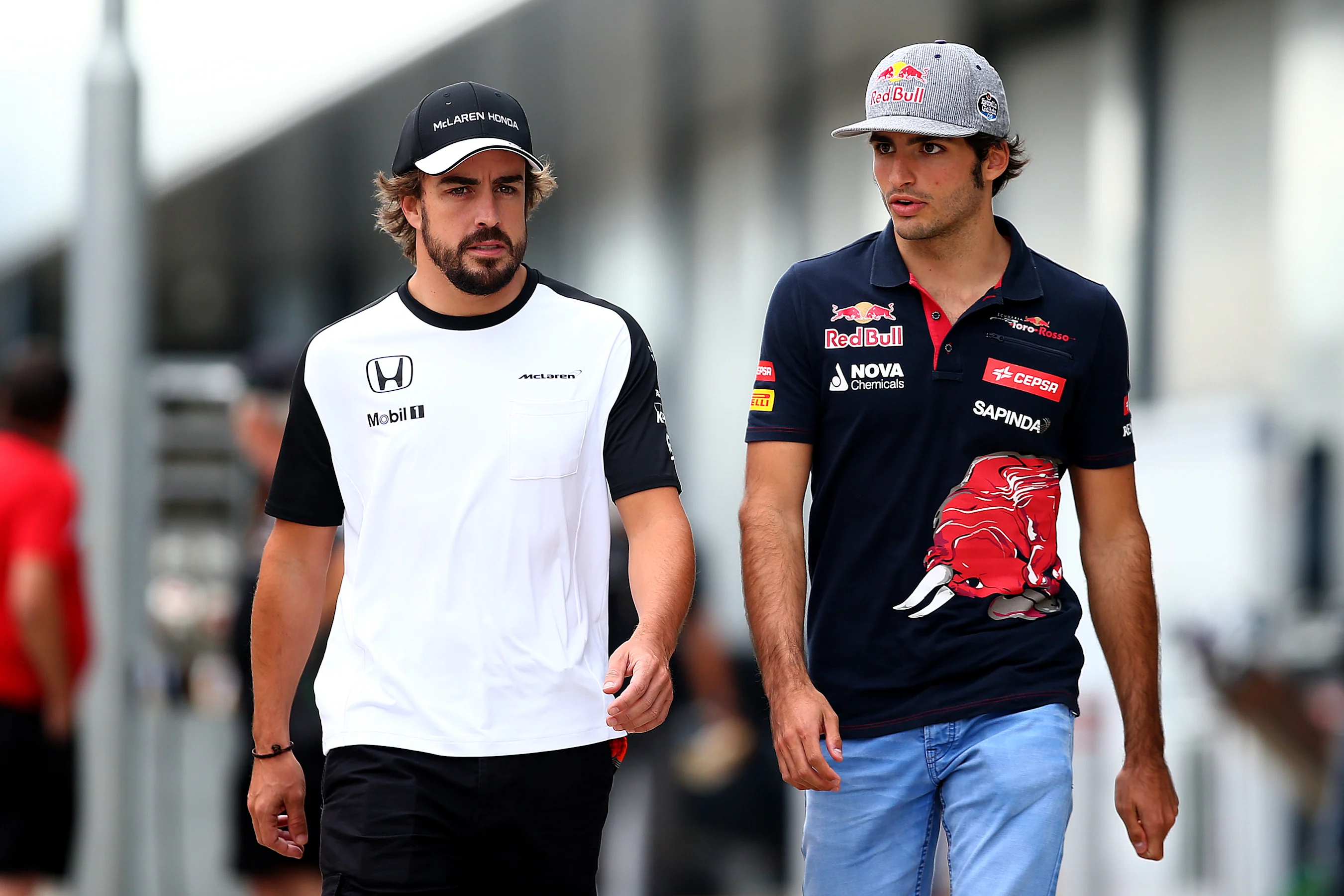 NORTHAMPTON, ENGLAND - JULY 03:  Carlos Sainz of Spain and Scuderia Toro Rosso speaks with Fernando