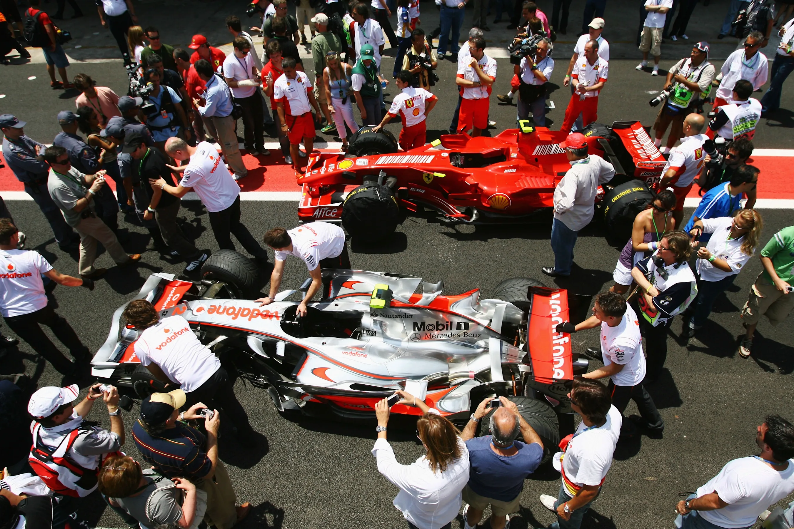 SAO PAULO, BRAZIL - OCTOBER 21: The cars of Lewis Hamilton (bottom) of Great Britain and McLaren
