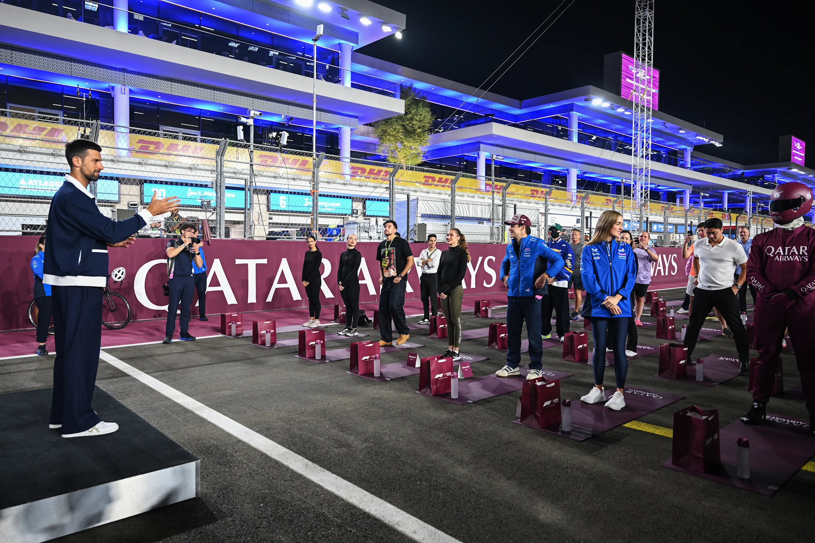 LUSAIL CITY, QATAR - NOVEMBER 27: Novak Djokovic leads an activity on the grid during previews