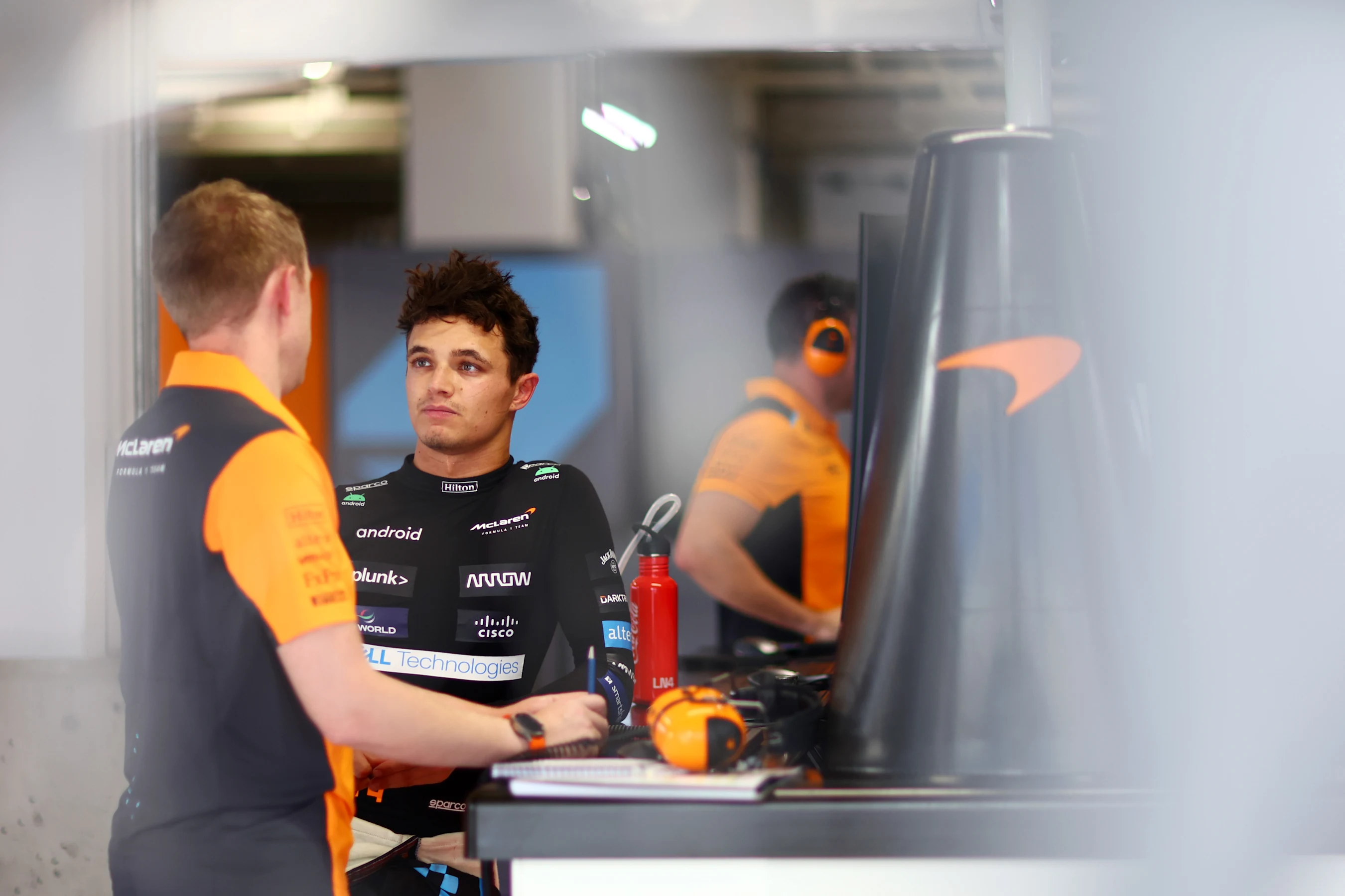 SUZUKA, JAPAN - SEPTEMBER 22: Lando Norris of Great Britain and McLaren talks with a McLaren team