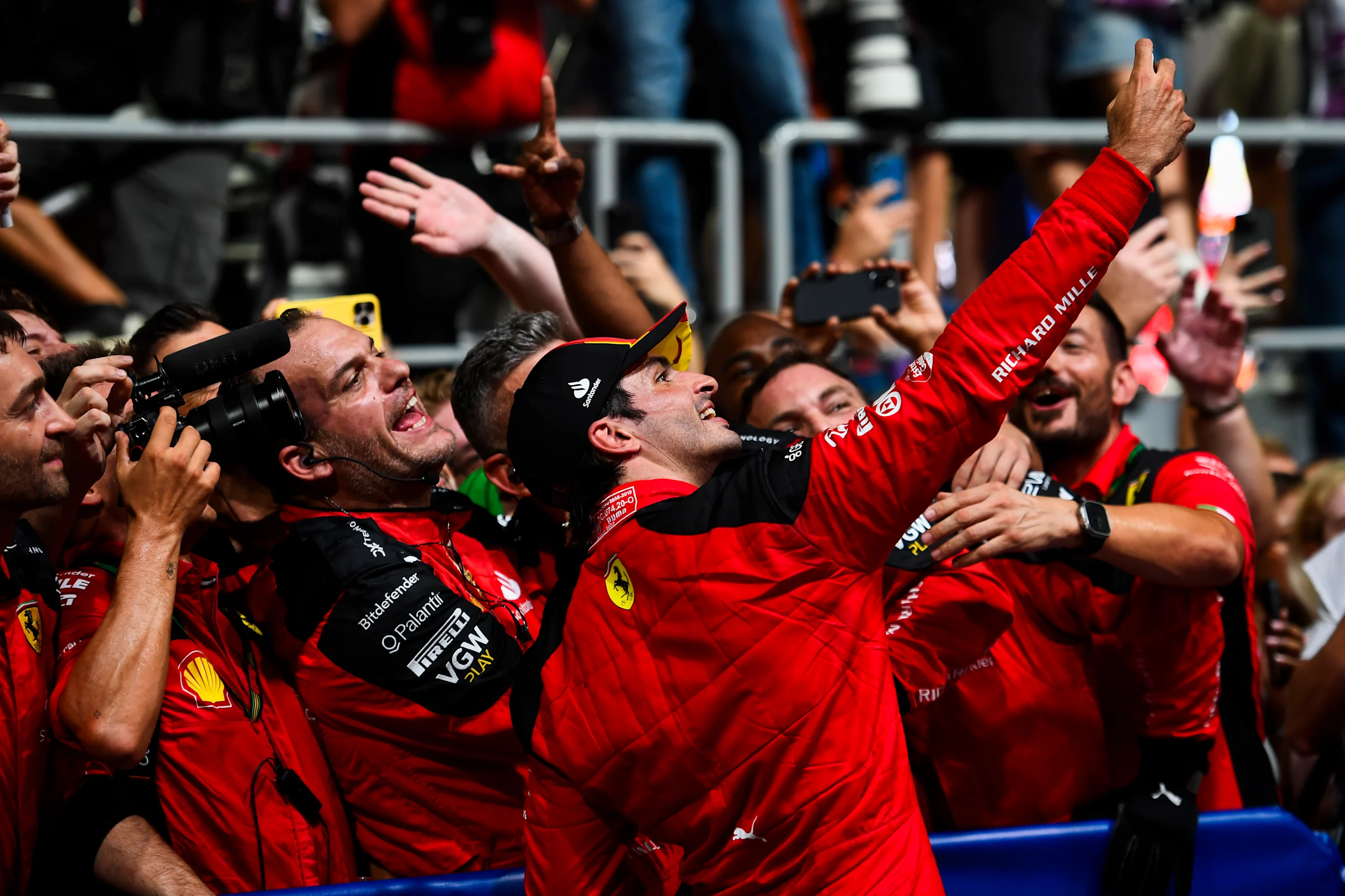 SINGAPORE, SINGAPORE - SEPTEMBER 17: Race winner Carlos Sainz of Spain and Ferrari celebrates with