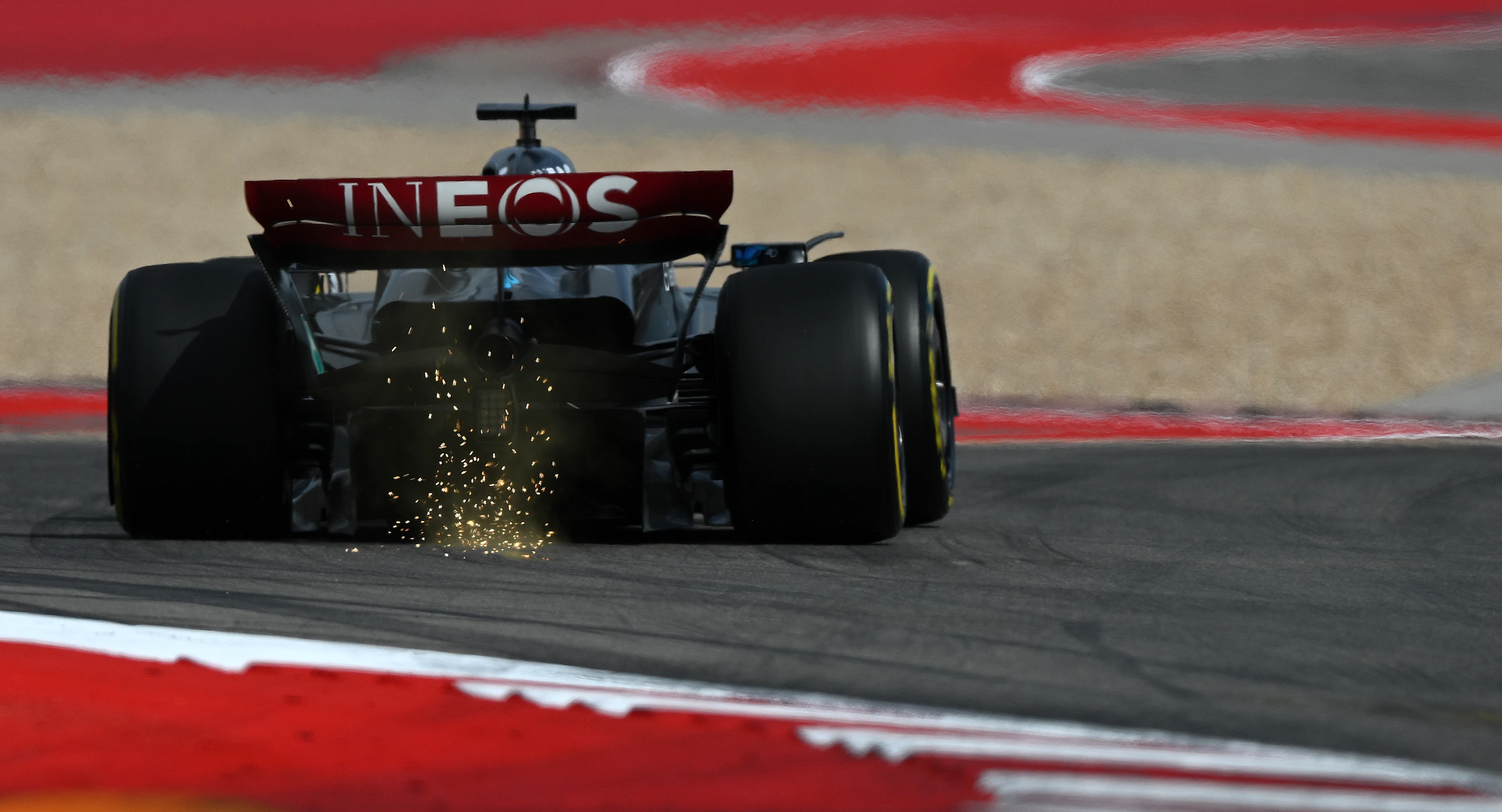 AUSTIN, TEXAS - OCTOBER 21: Sparks fly behind George Russell of Great Britain driving the (63)
