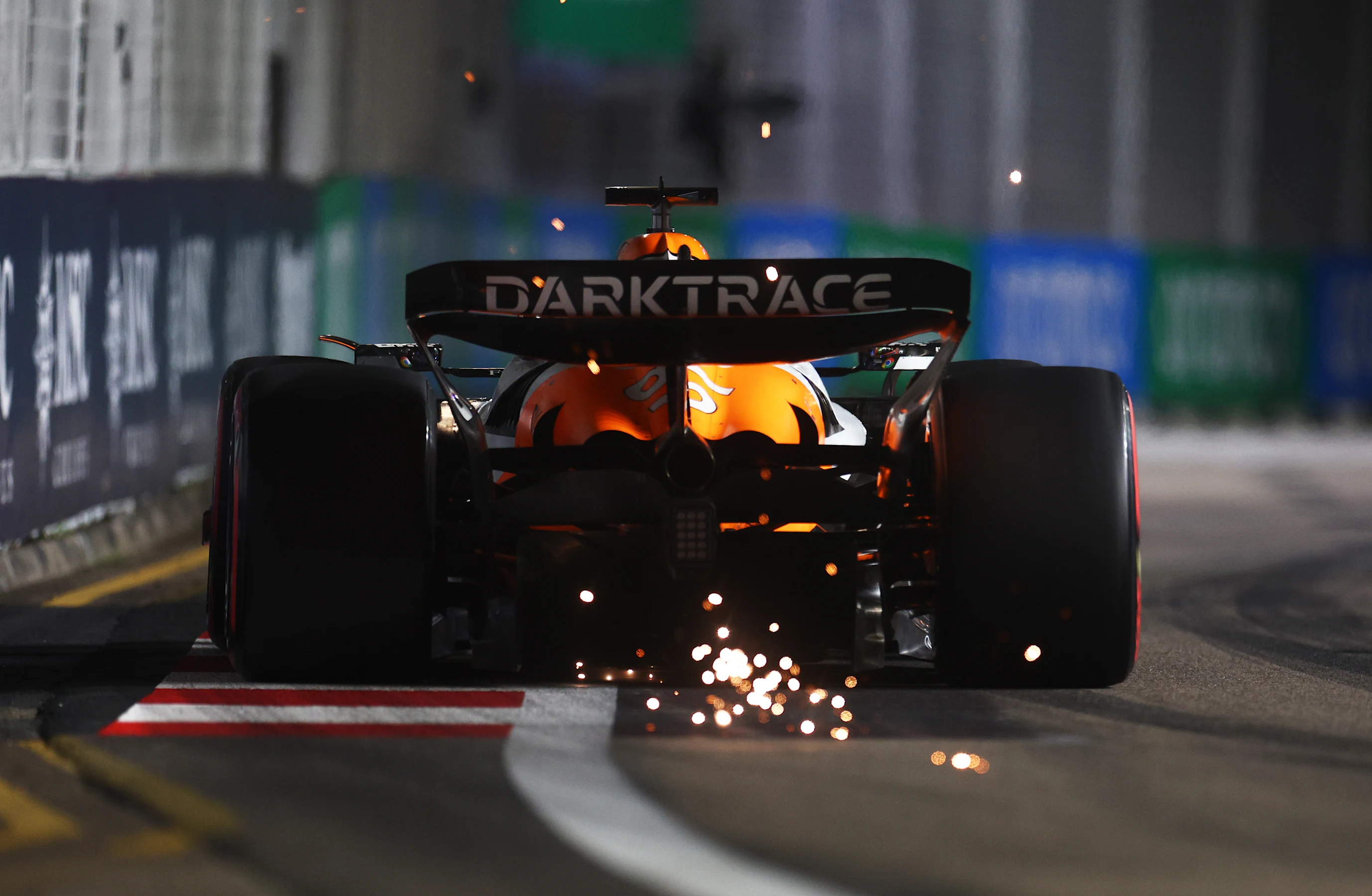 SINGAPORE, SINGAPORE - SEPTEMBER 21: Sparks fly behind Oscar Piastri of Australia driving the (81)