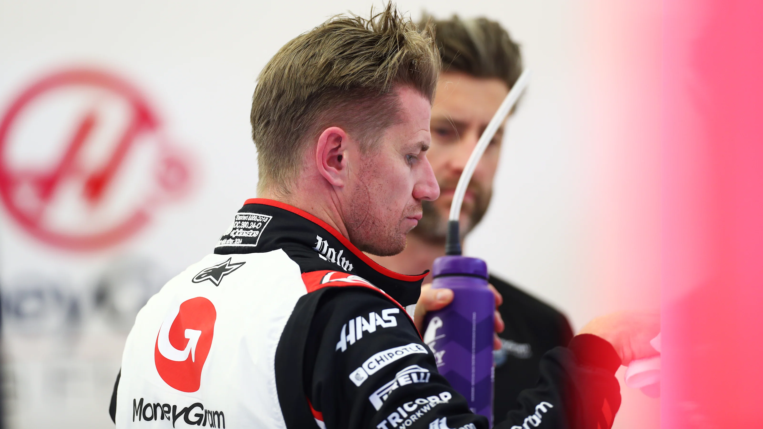 BAHRAIN, BAHRAIN - MARCH 01: Nico Hulkenberg of Germany and Haas F1 looks on in the garage during