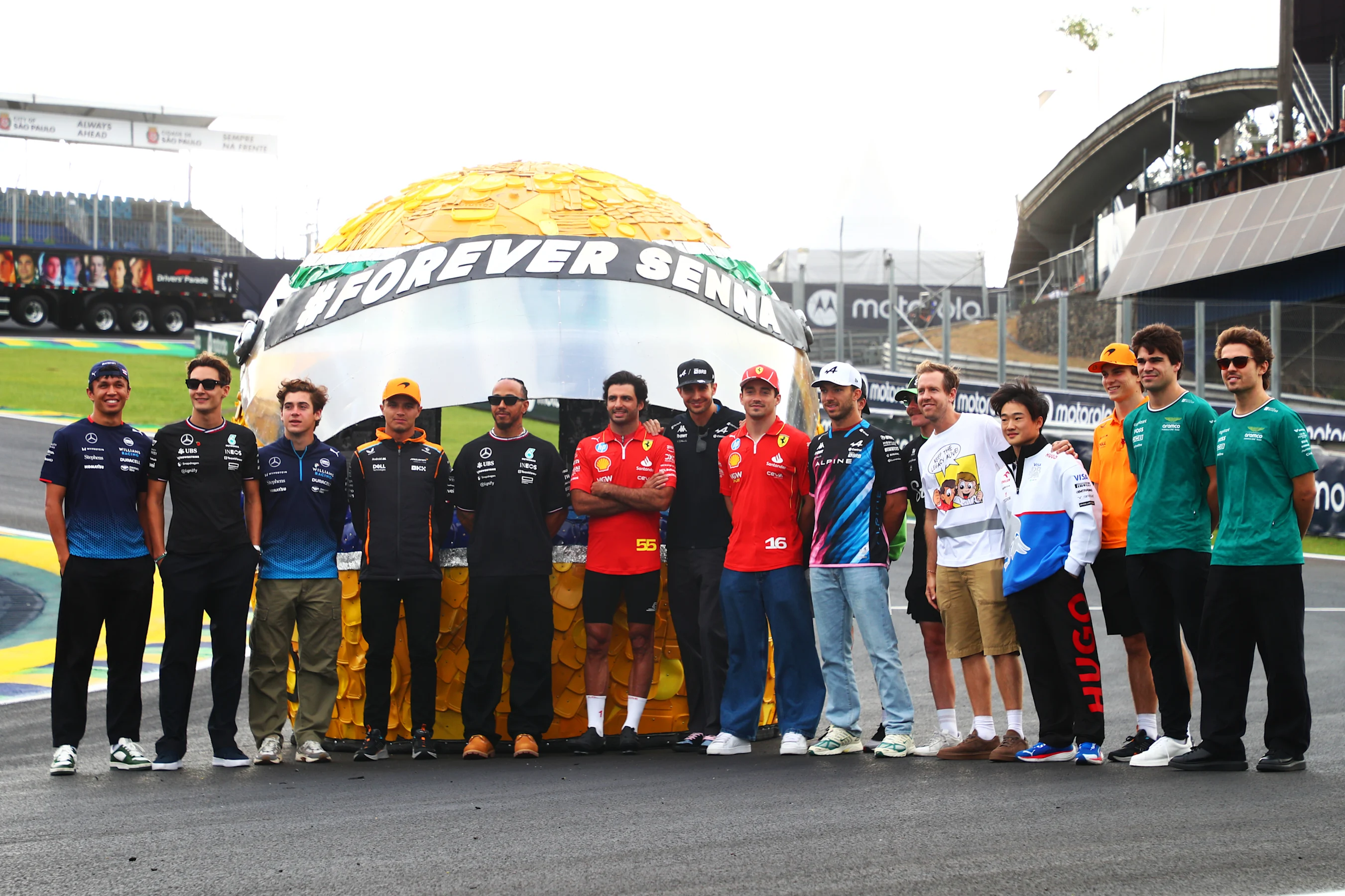 SAO PAULO, BRAZIL - OCTOBER 31: The F1 drivers pose for a photo with a giant Ayrton Senna helmet on
