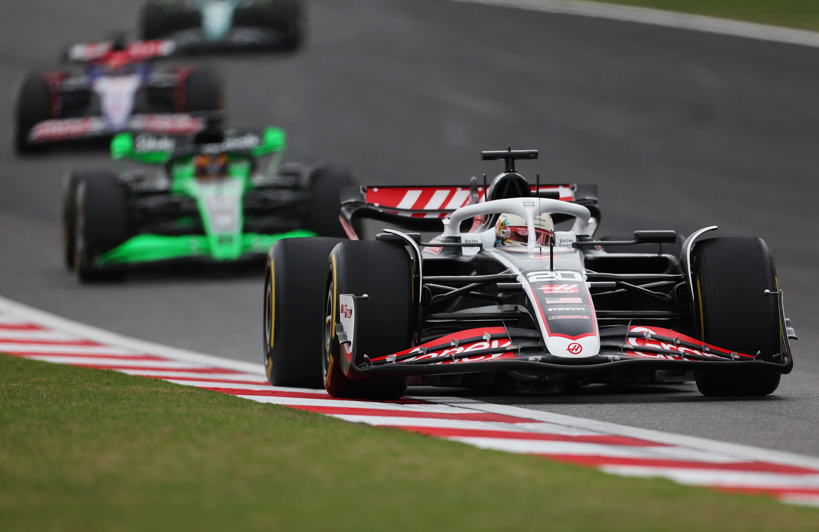 SHANGHAI, CHINA - APRIL 20: Kevin Magnussen of Denmark driving the (20) Haas F1 VF-24 Ferrari leads