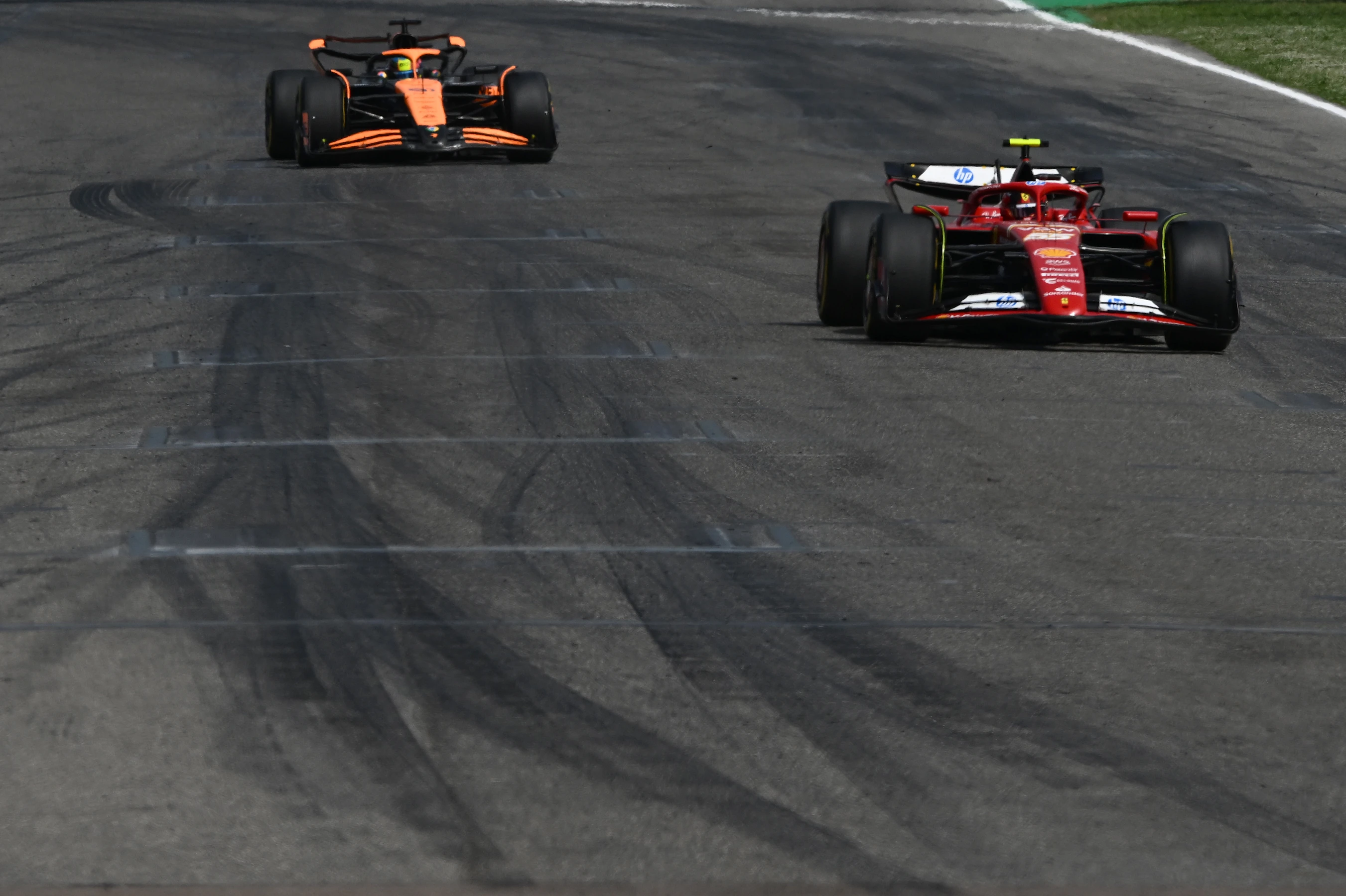 IMOLA, ITALY - MAY 19: Carlos Sainz of Spain driving (55) the Ferrari SF-24 leads Oscar Piastri of