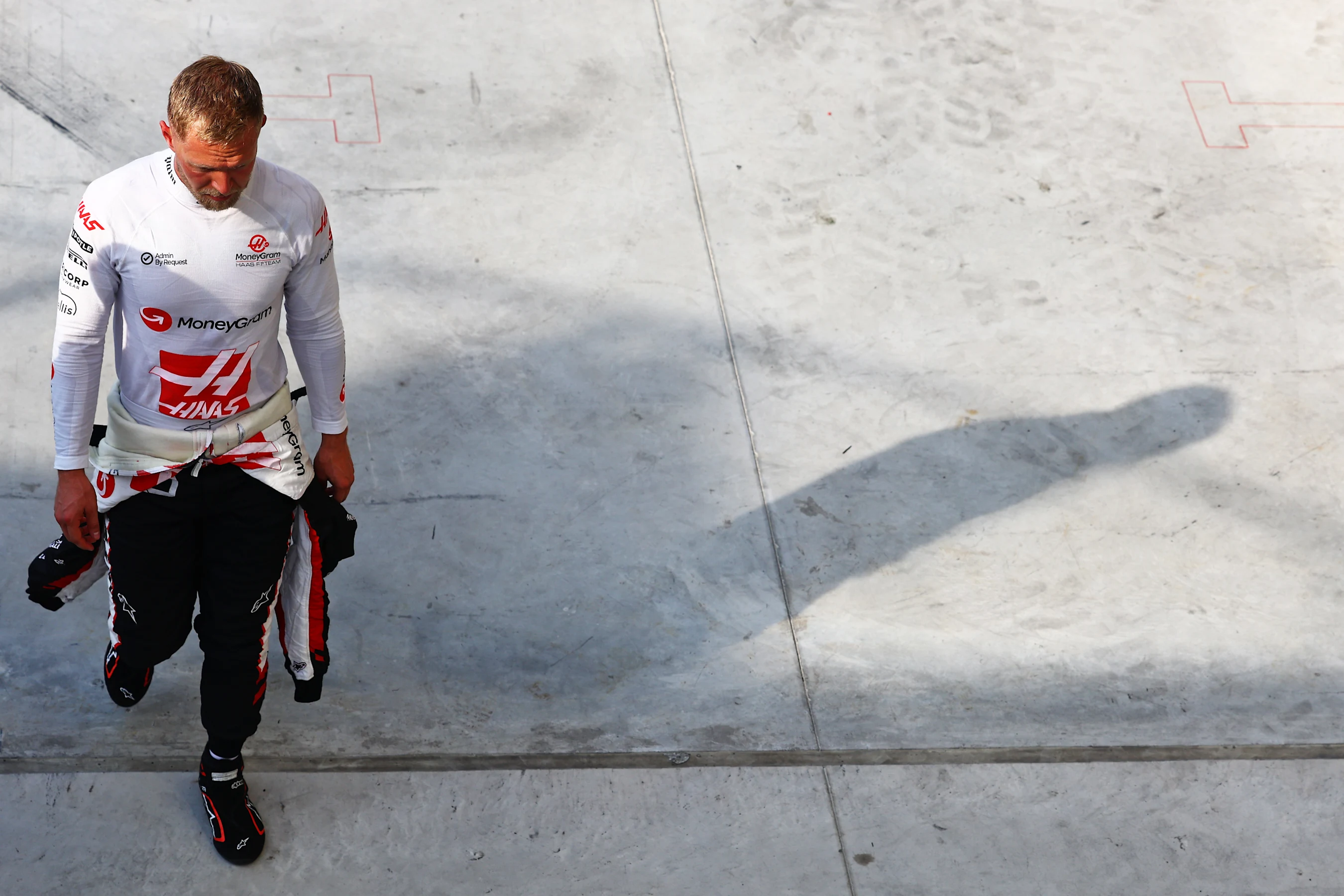 MONZA, ITALY - AUGUST 31: Thirteenth qualifier Kevin Magnussen of Denmark and Haas F1 walks in the