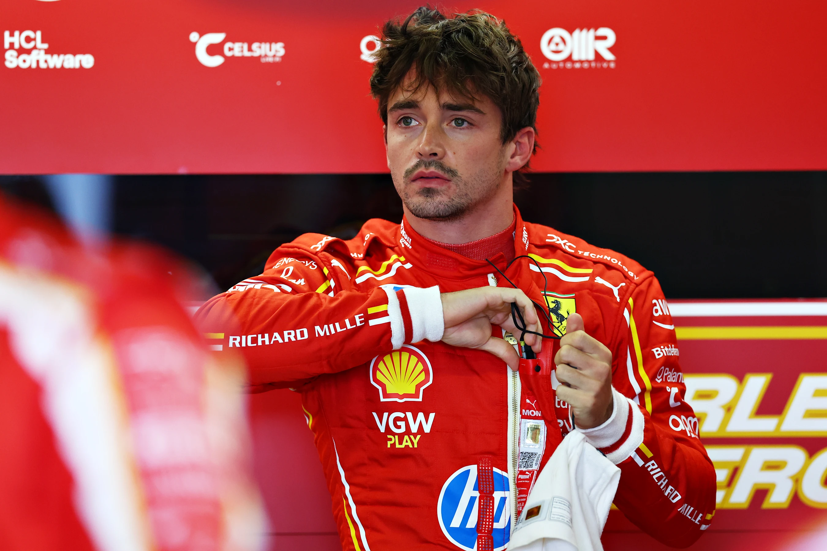 MEXICO CITY, MEXICO - OCTOBER 25: Charles Leclerc of Monaco and Ferrari looks on in the garage