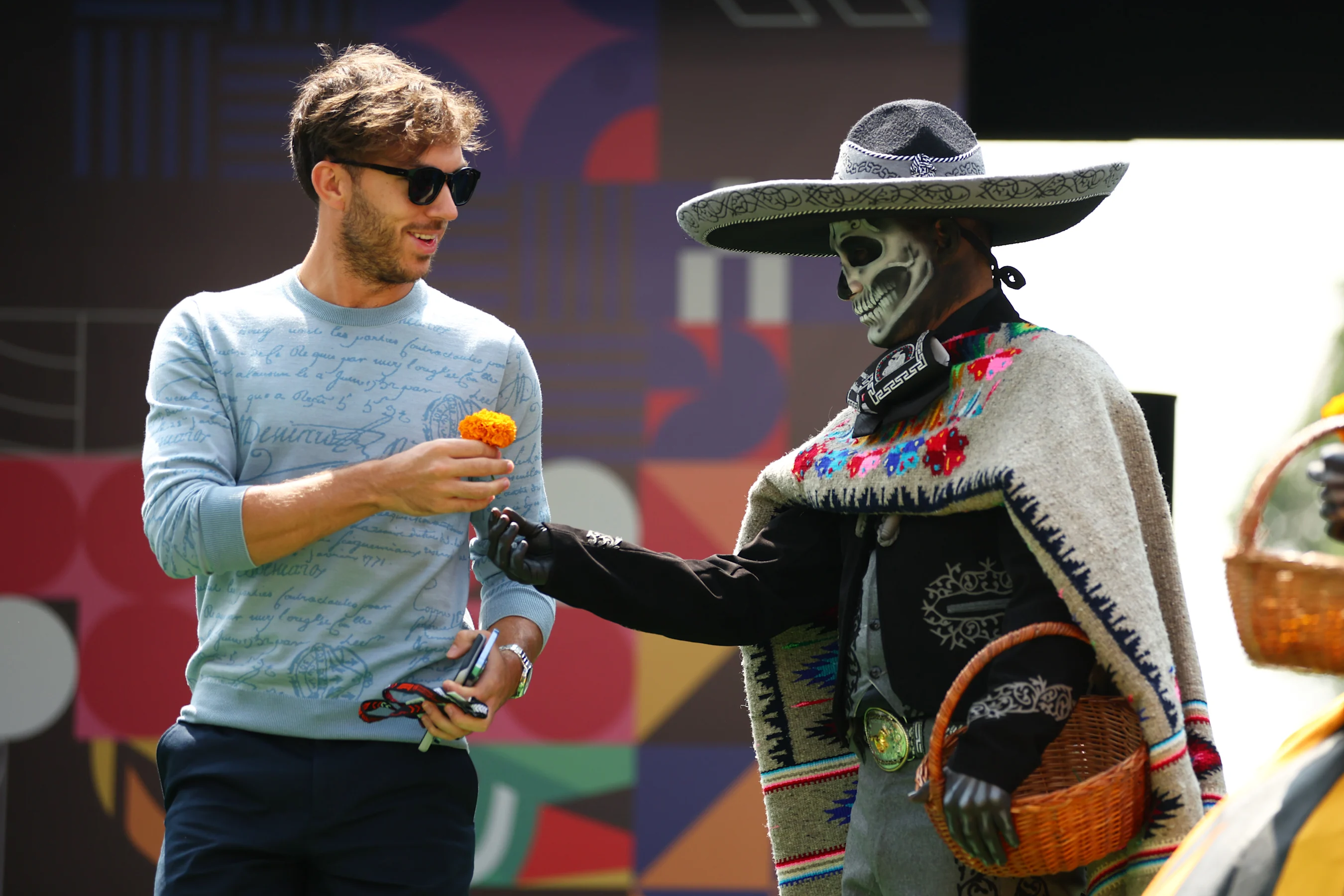 MEXICO CITY, MEXICO - OCTOBER 24: Pierre Gasly of France and Alpine F1 is given a flower by a Day