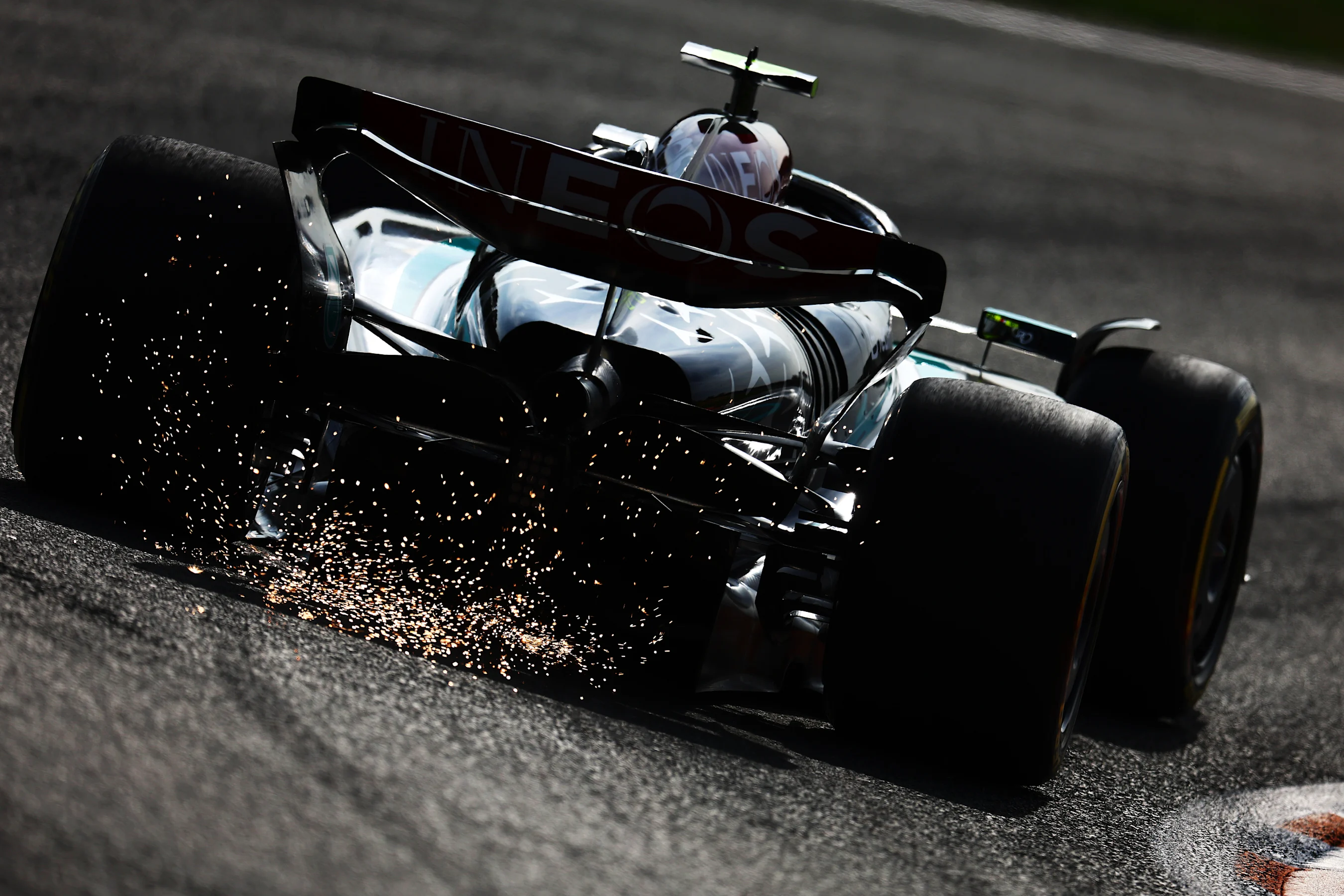 ZANDVOORT, NETHERLANDS - AUGUST 23: Sparks fly behind Lewis Hamilton of Great Britain driving the