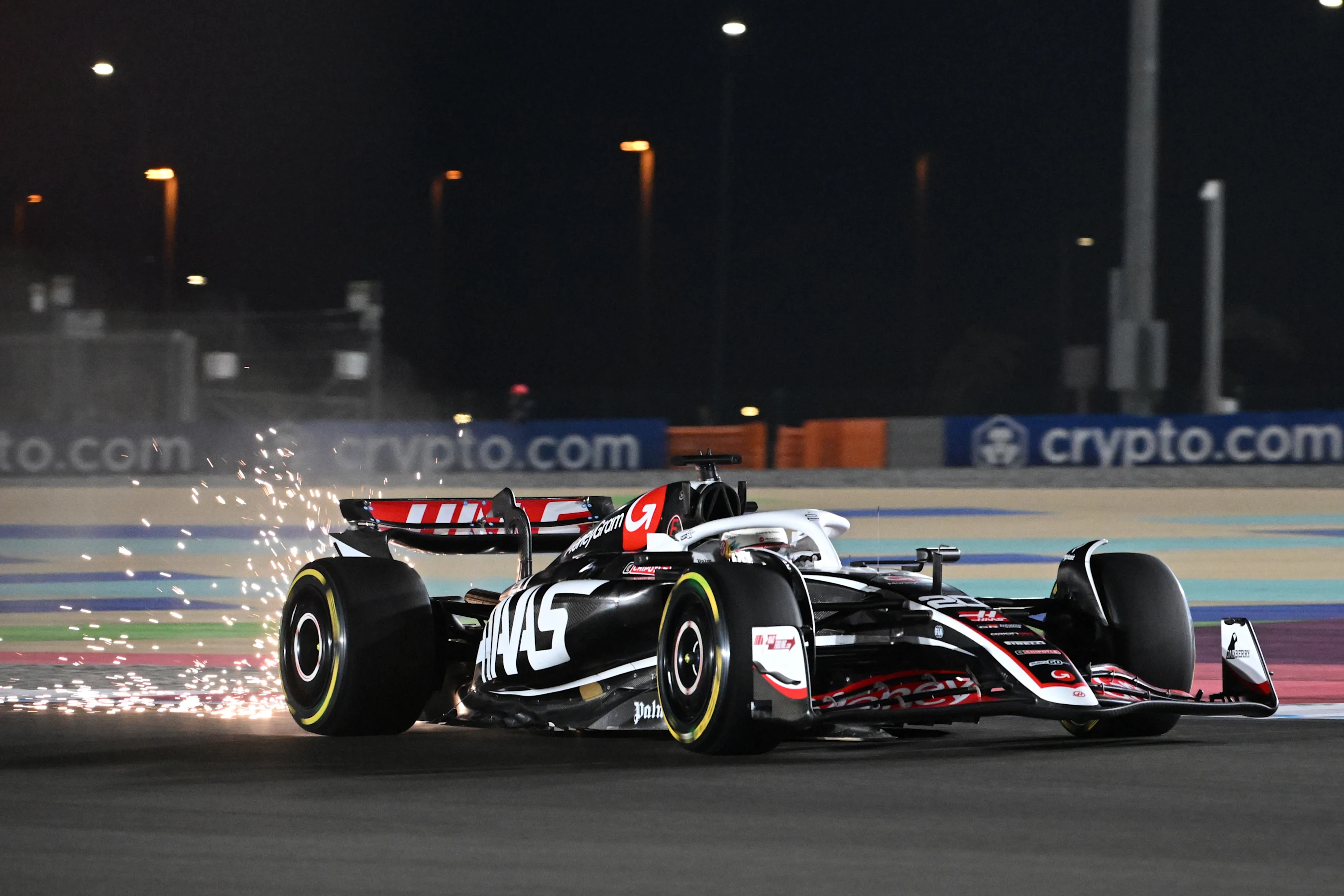 LUSAIL CITY, QATAR - NOVEMBER 29: Sparks fly behind Kevin Magnussen of Denmark driving the (20)