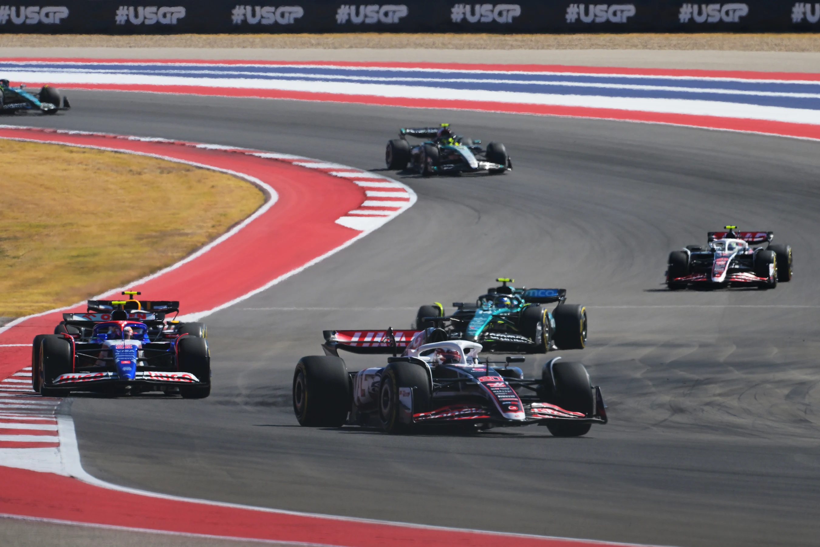 AUSTIN, TEXAS - OCTOBER 20: Kevin Magnussen of Denmark driving the (20) Haas F1 VF-24 Ferrari leads