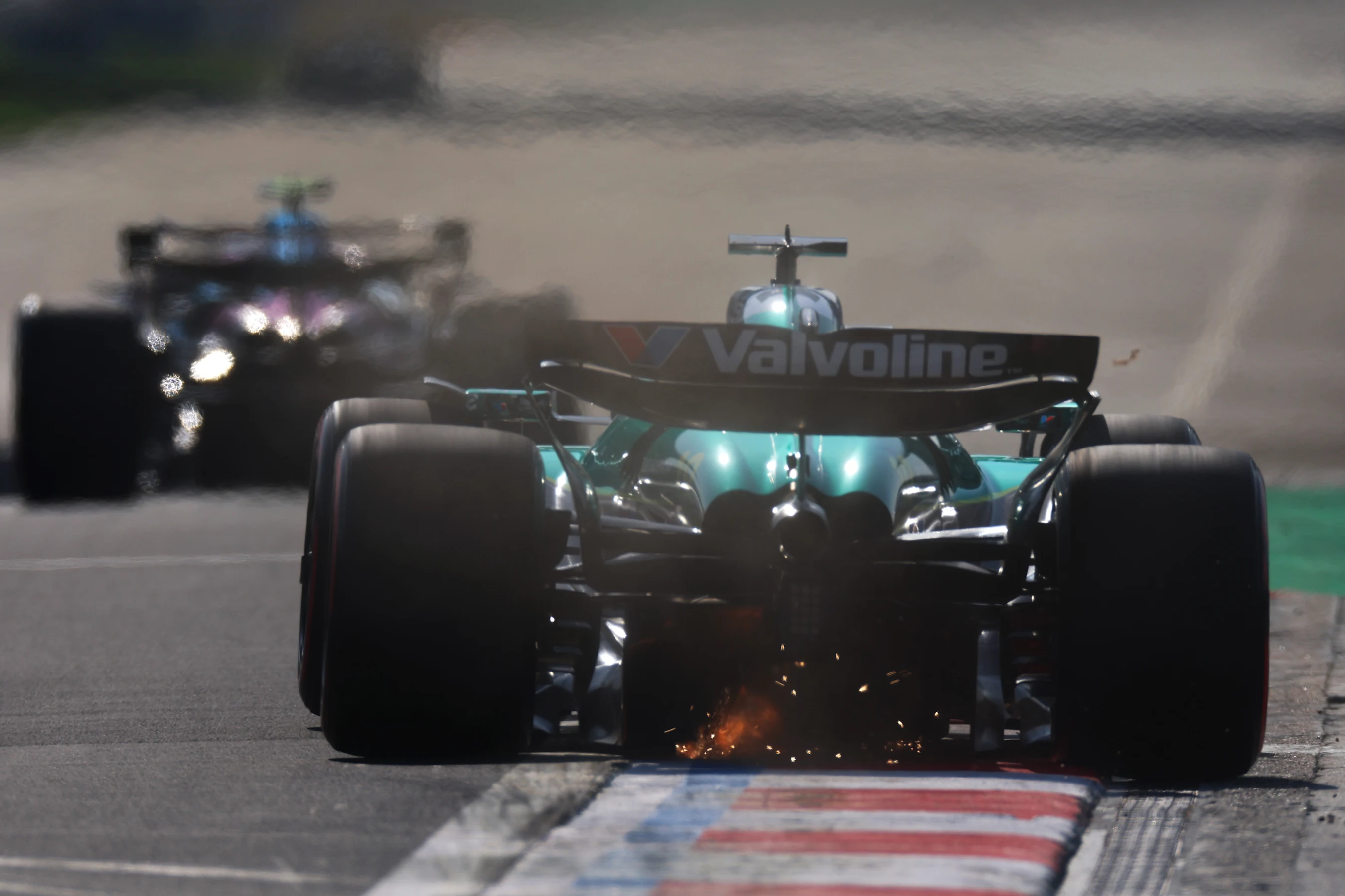 SHANGHAI, CHINA - MARCH 22: Sparks fly behind Lance Stroll of Canada driving the (18) Aston Martin