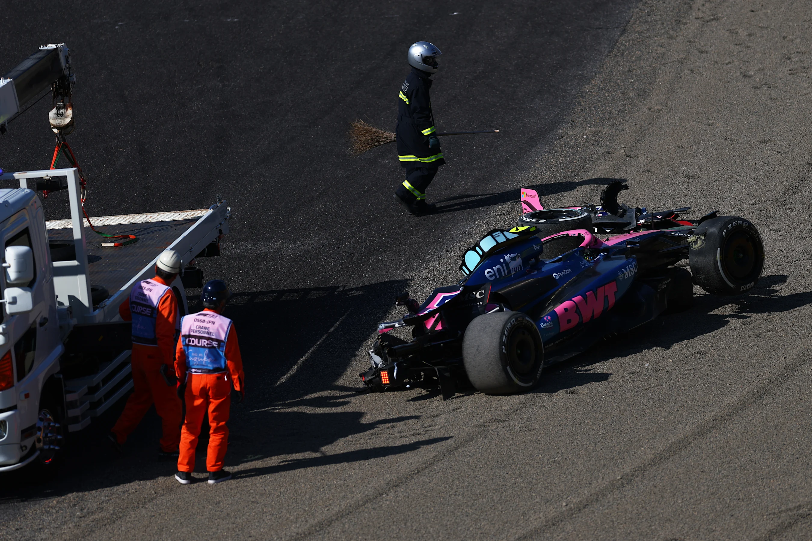 SUZUKA, JAPAN - APRIL 04: Marshals remove the damaged car of Jack Doohan of Australia driving the
