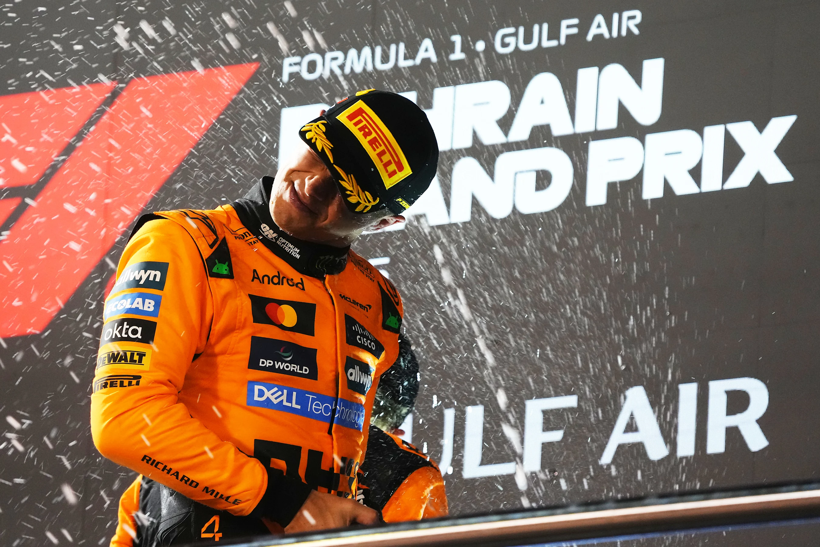 BAHRAIN, BAHRAIN - APRIL 13: Third placed Lando Norris of Great Britain and McLaren celebrates on