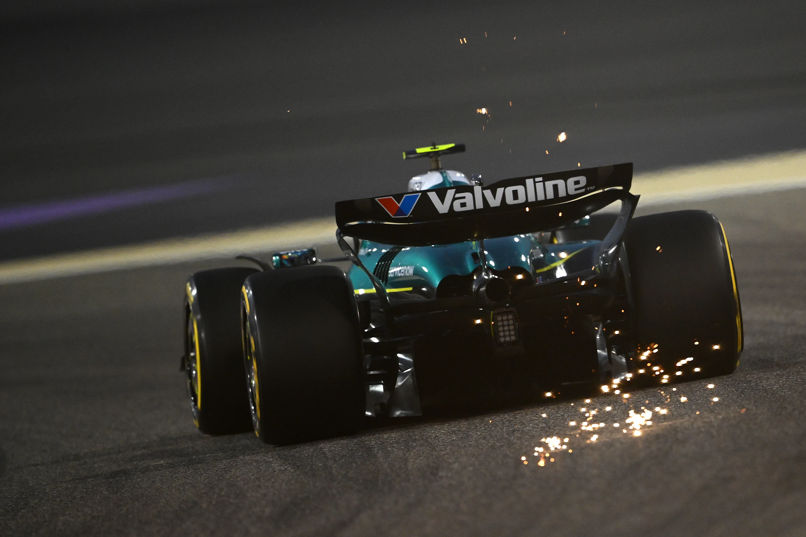 BAHRAIN, BAHRAIN - APRIL 11: Sparks fly behind Fernando Alonso of Spain driving the (14) Aston