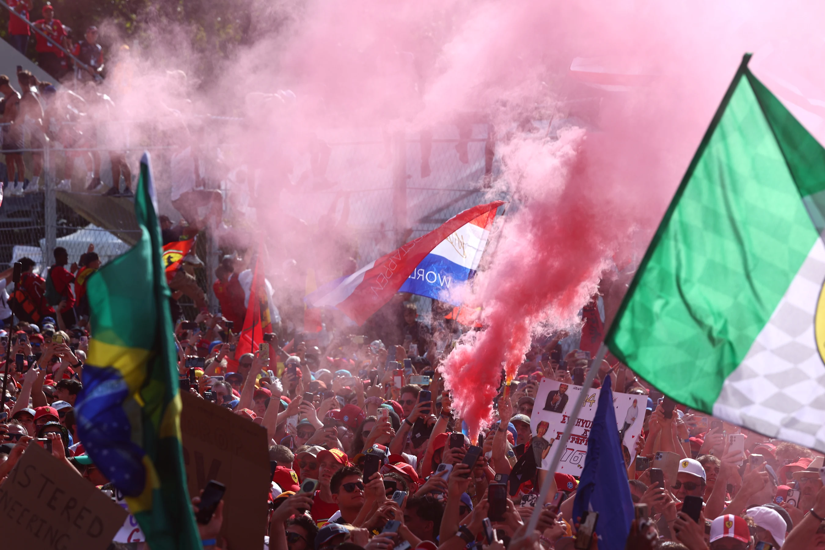 MONZA, ITALY - SEPTEMBER 07: Fans fill the air with smoke at the podium ceremony during the F1