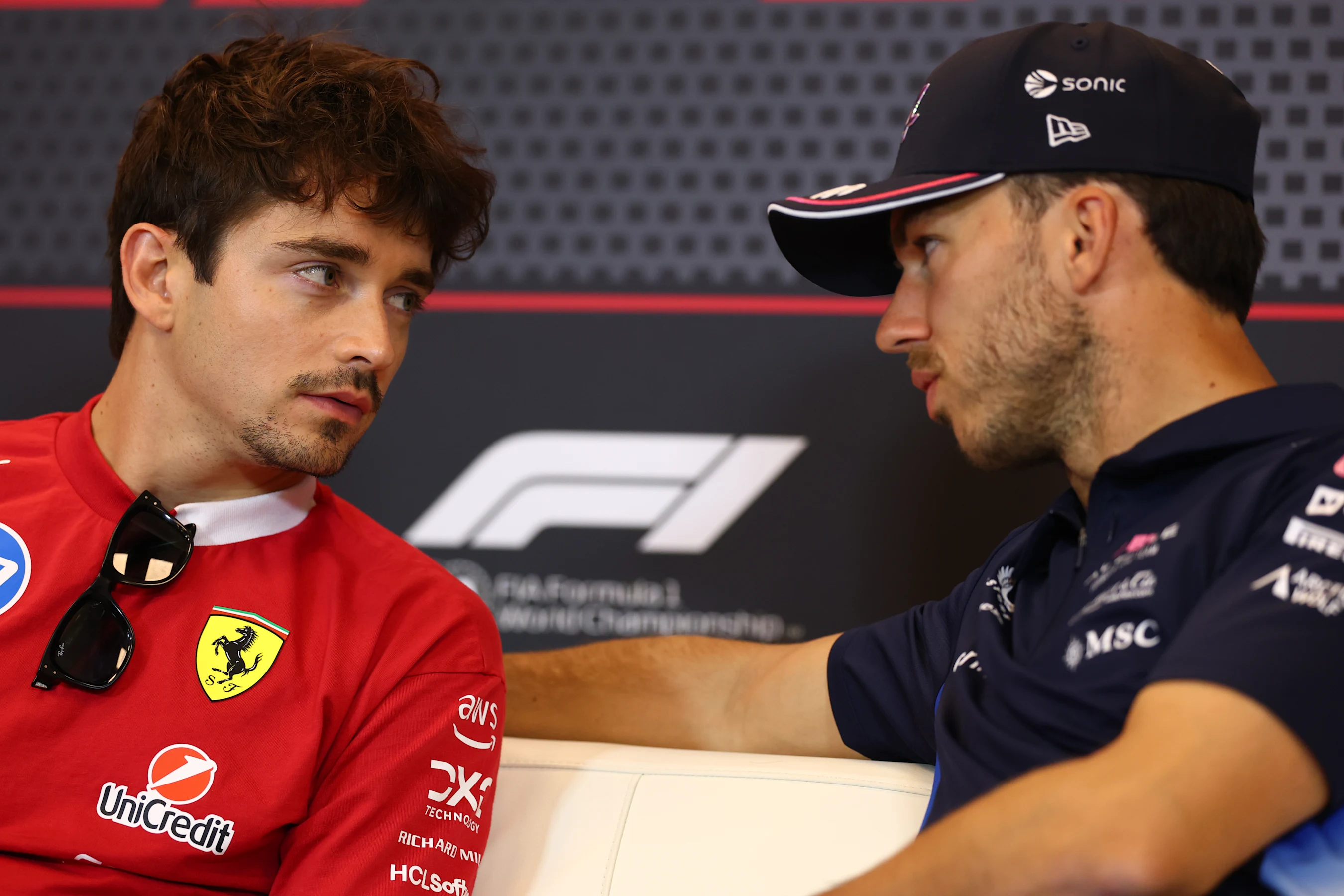 MONTE-CARLO, MONACO - MAY 22: Charles Leclerc of Monaco and Scuderia Ferrari talks with Pierre