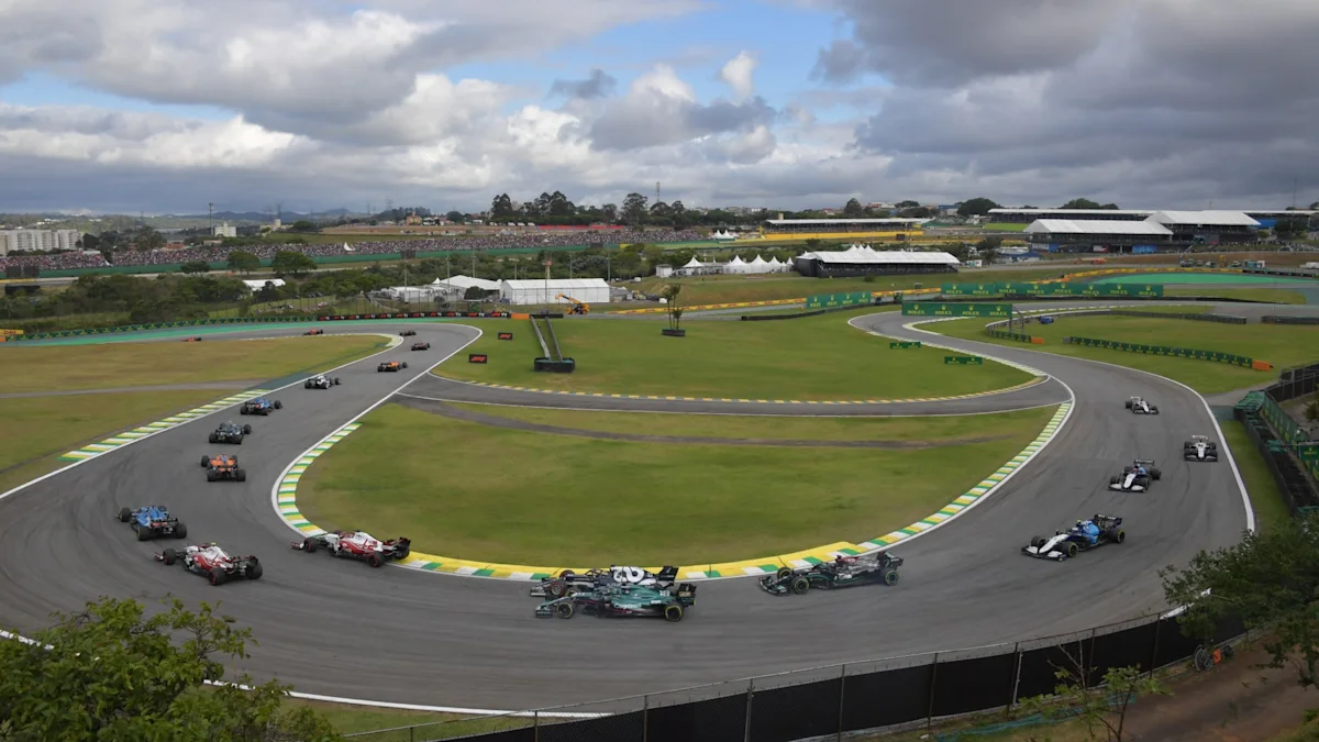 The Formula 1 field snakes through the Interlagos infield.