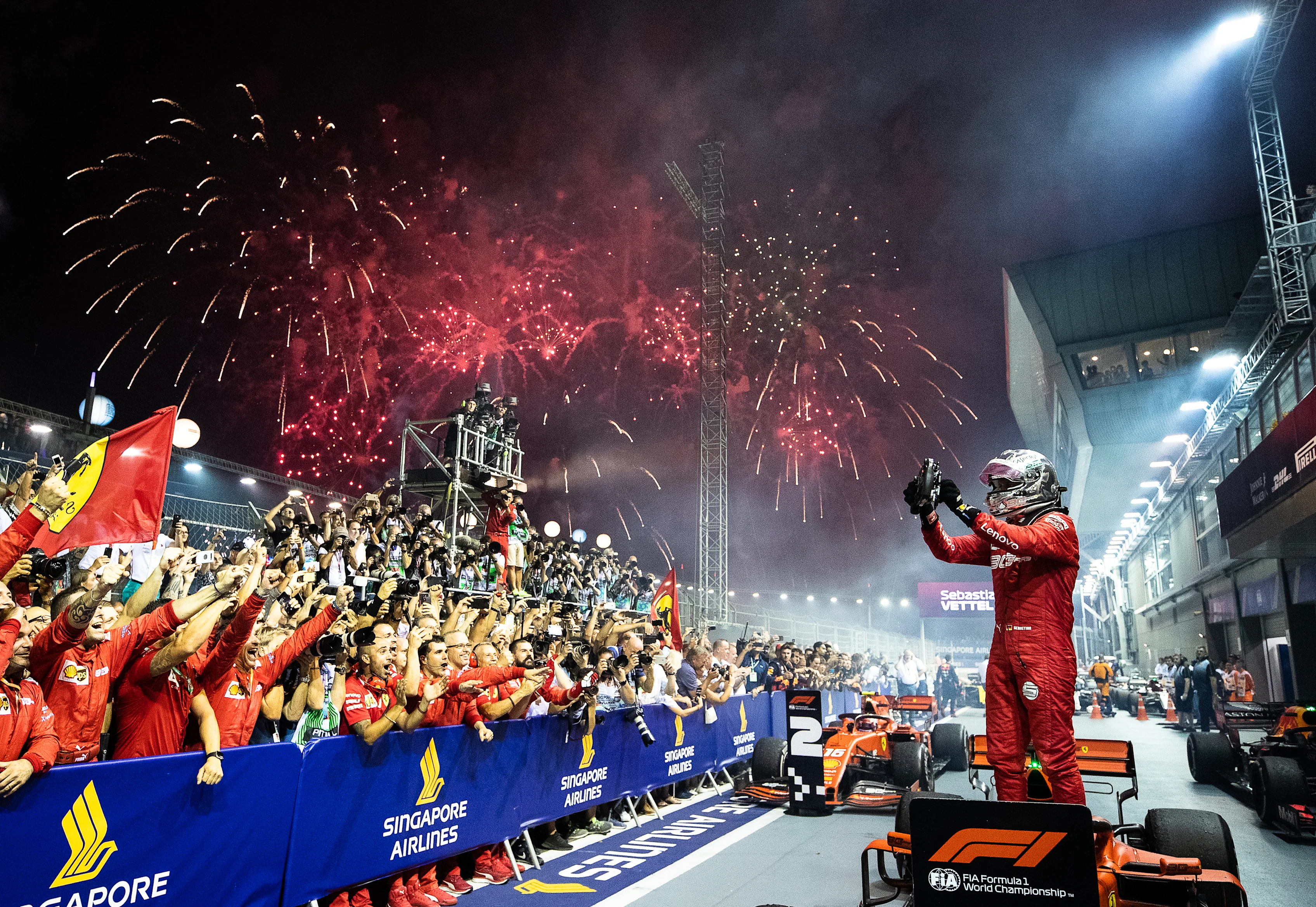 SINGAPORE, SINGAPORE - SEPTEMBER 22: Race winner Sebastian Vettel of Germany and Ferrari celebrates