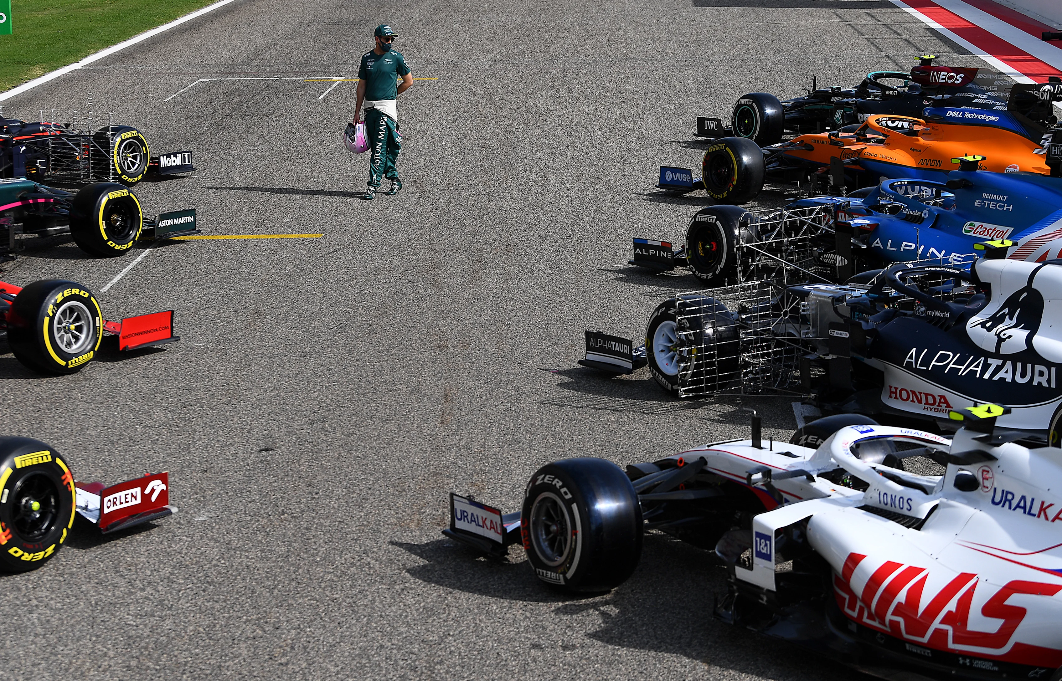 BAHRAIN, BAHRAIN - MARCH 12: Sebastian Vettel of Germany and Aston Martin walks amongst the cars on
