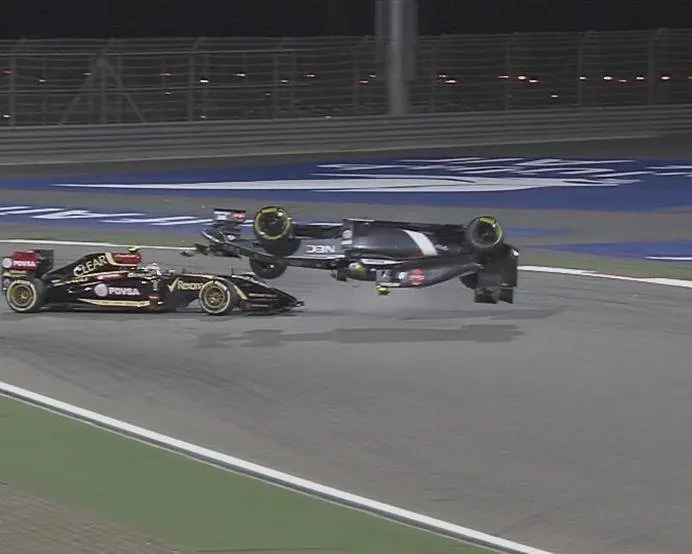 Pastor Maldonado's Lotus collides with the Sauber of Esteban Gutierrez at Turn 1, flipping it over and bringing out the safety car. © FOWC Ltd