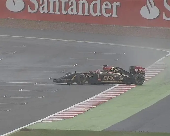 As conditions worsen, Romain Grosjean's Lotus slides sideways across the line. © FOWC Ltd