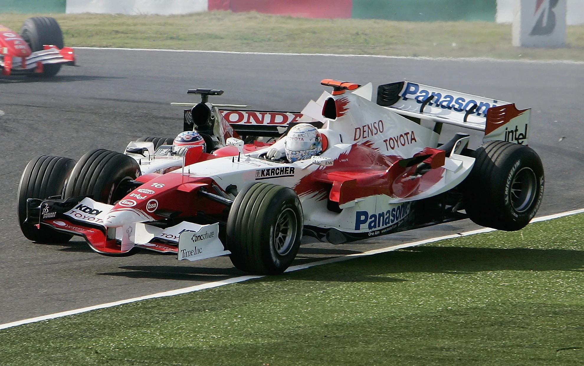 SUZUKA, JAPAN - OCTOBER 09:  Jarno Trulli of Italy and Toyota collides with Takuma Sato of Japan