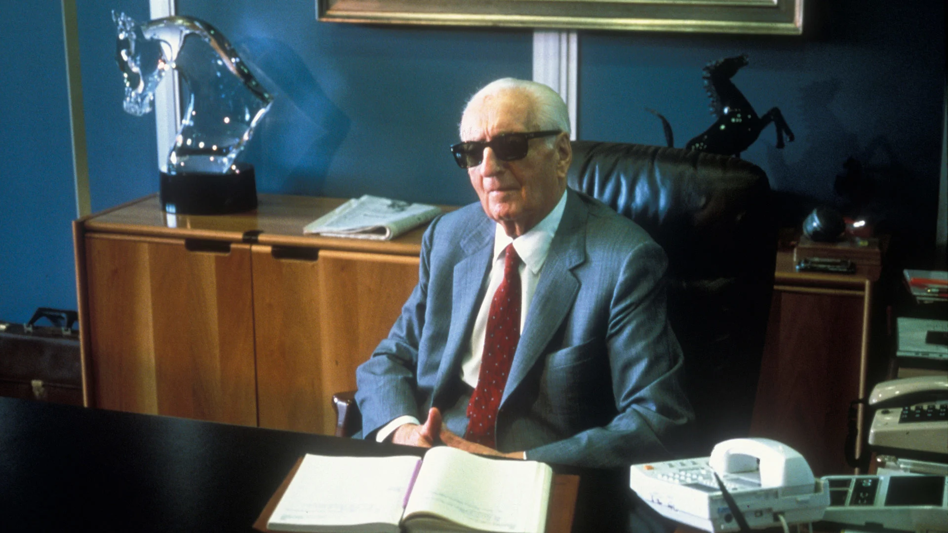 Enzo Ferrari the founder of the Scuderia Ferrari Grand Prix motor racing team sits at his office