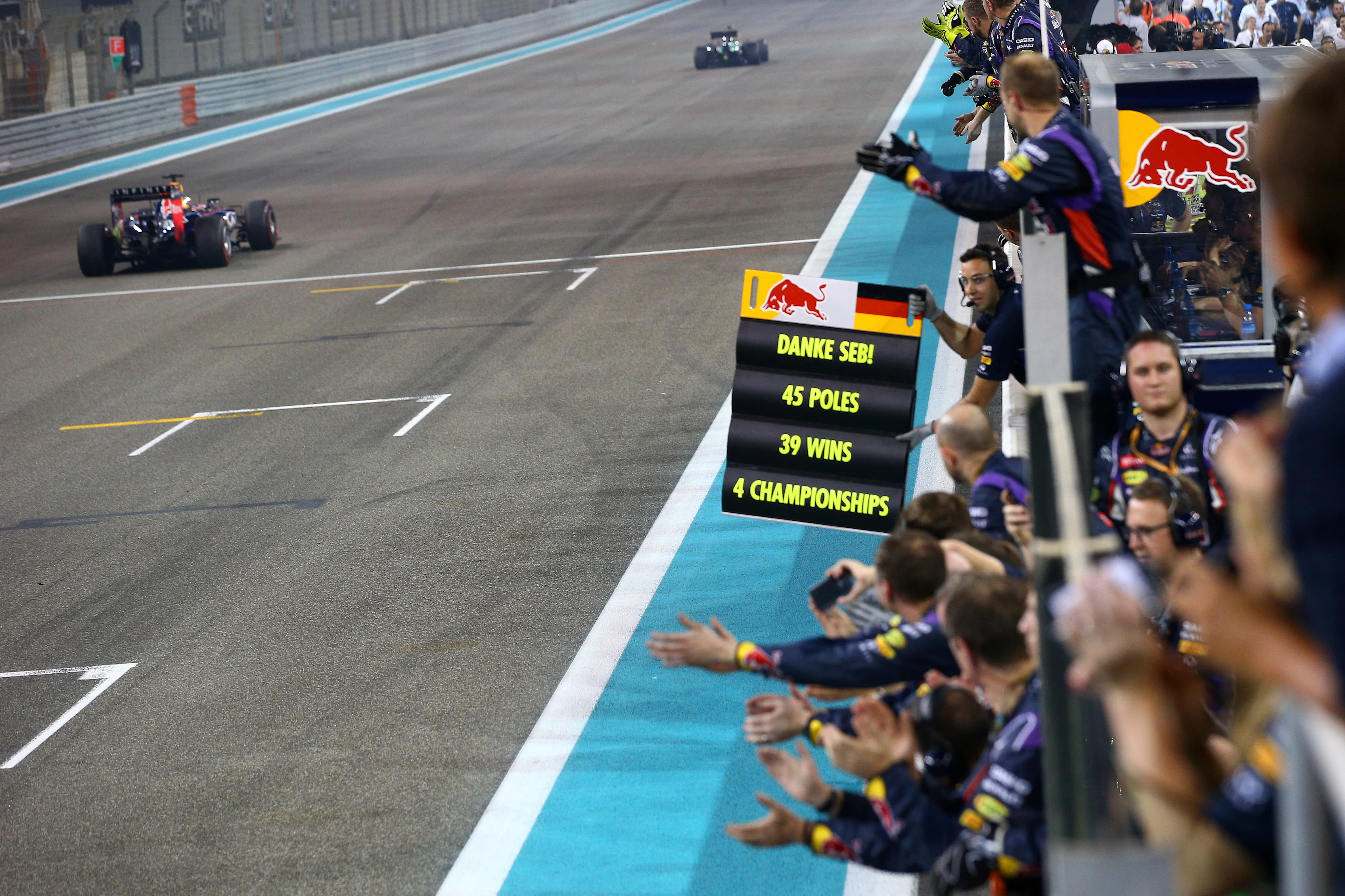 ABU DHABI, UNITED ARAB EMIRATES - NOVEMBER 23:  Members of the Infiniti Red Bull Racing team cheer