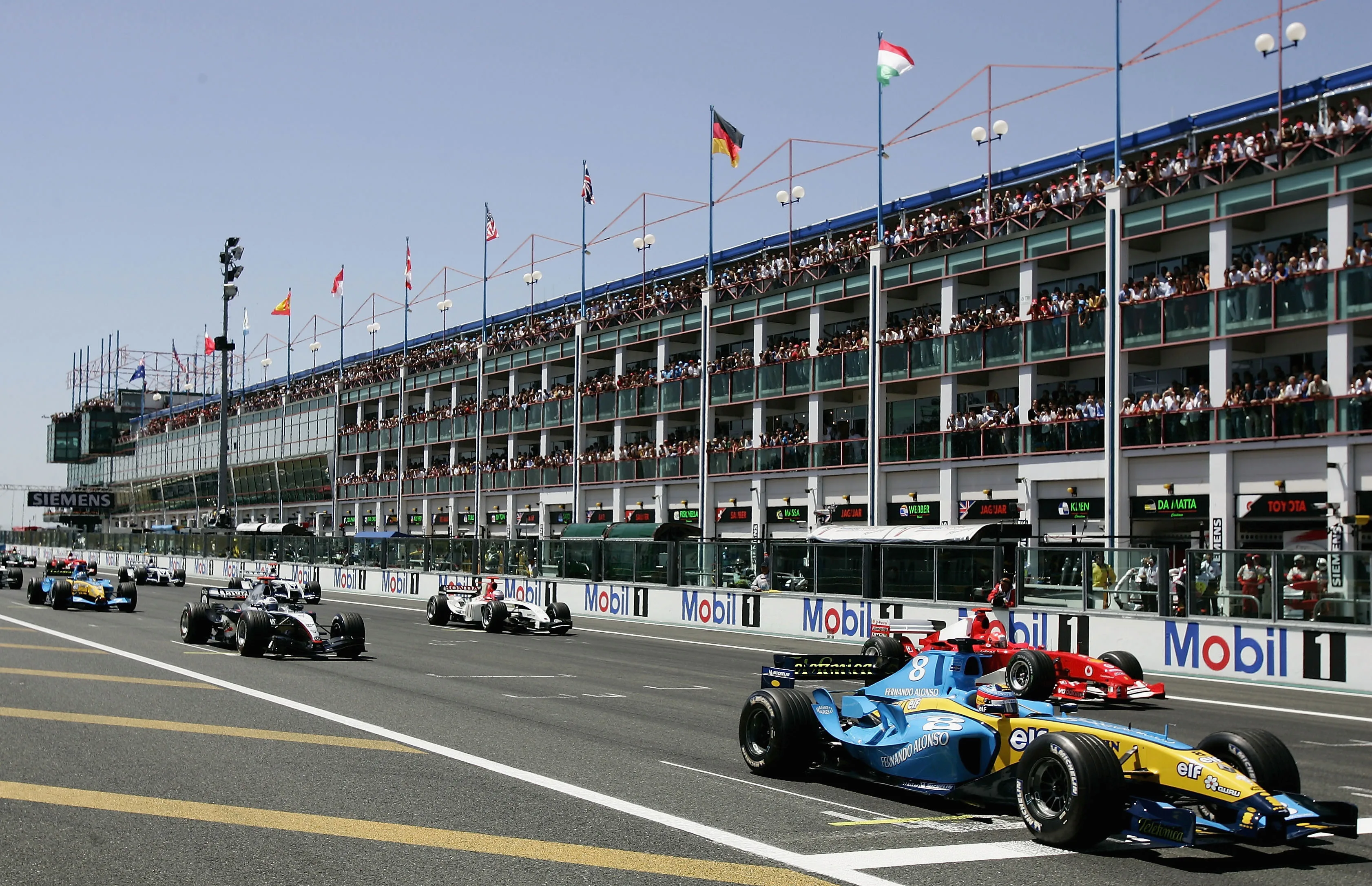 MAGNY-COURS, FRANCE - JULY 4: Fernando Alonso of Spain and Renault is first to get away off the