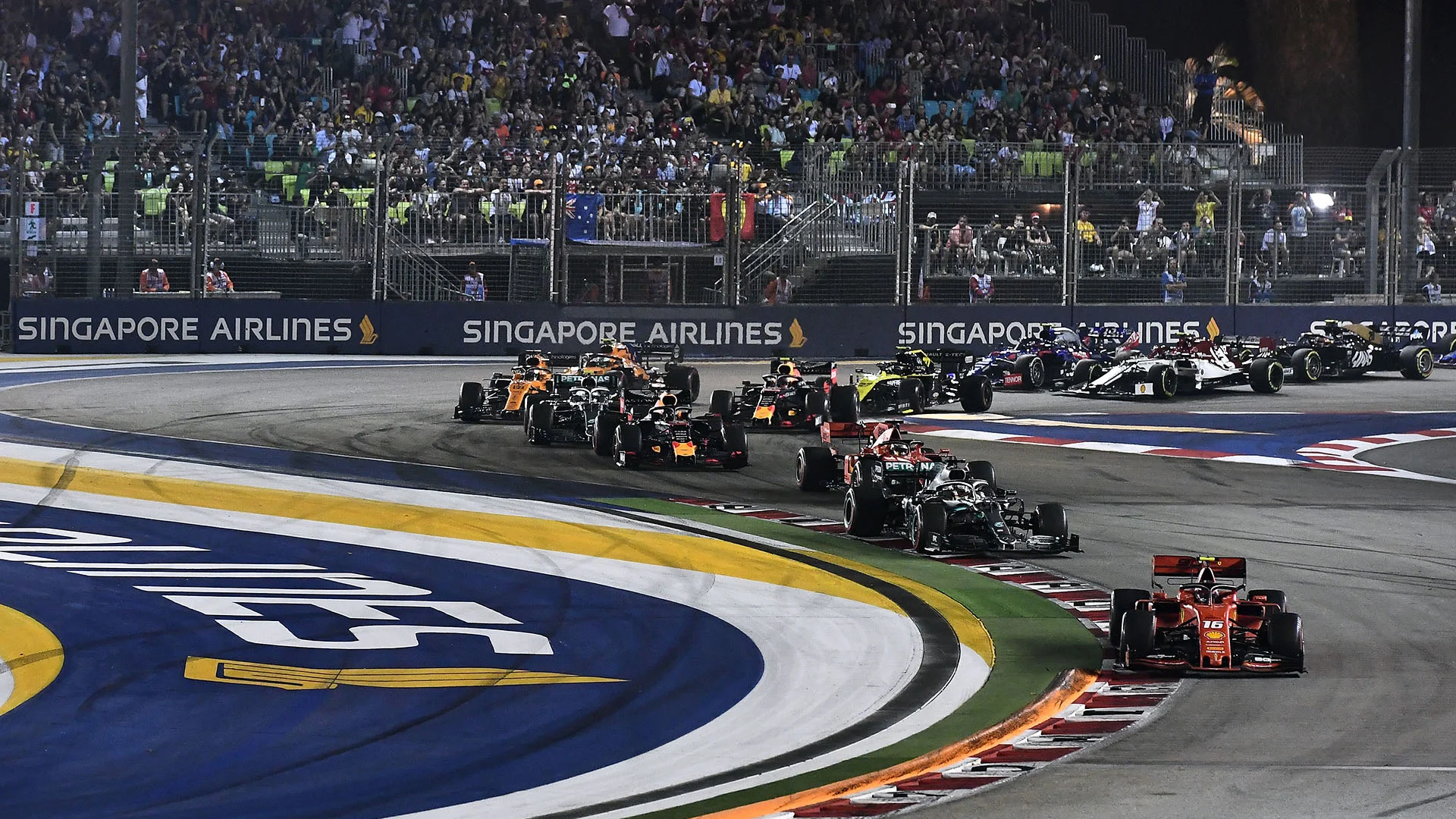 Ferrari's Monegasque driver Charles Leclerc (bottom R) leads the pack during the Formula One