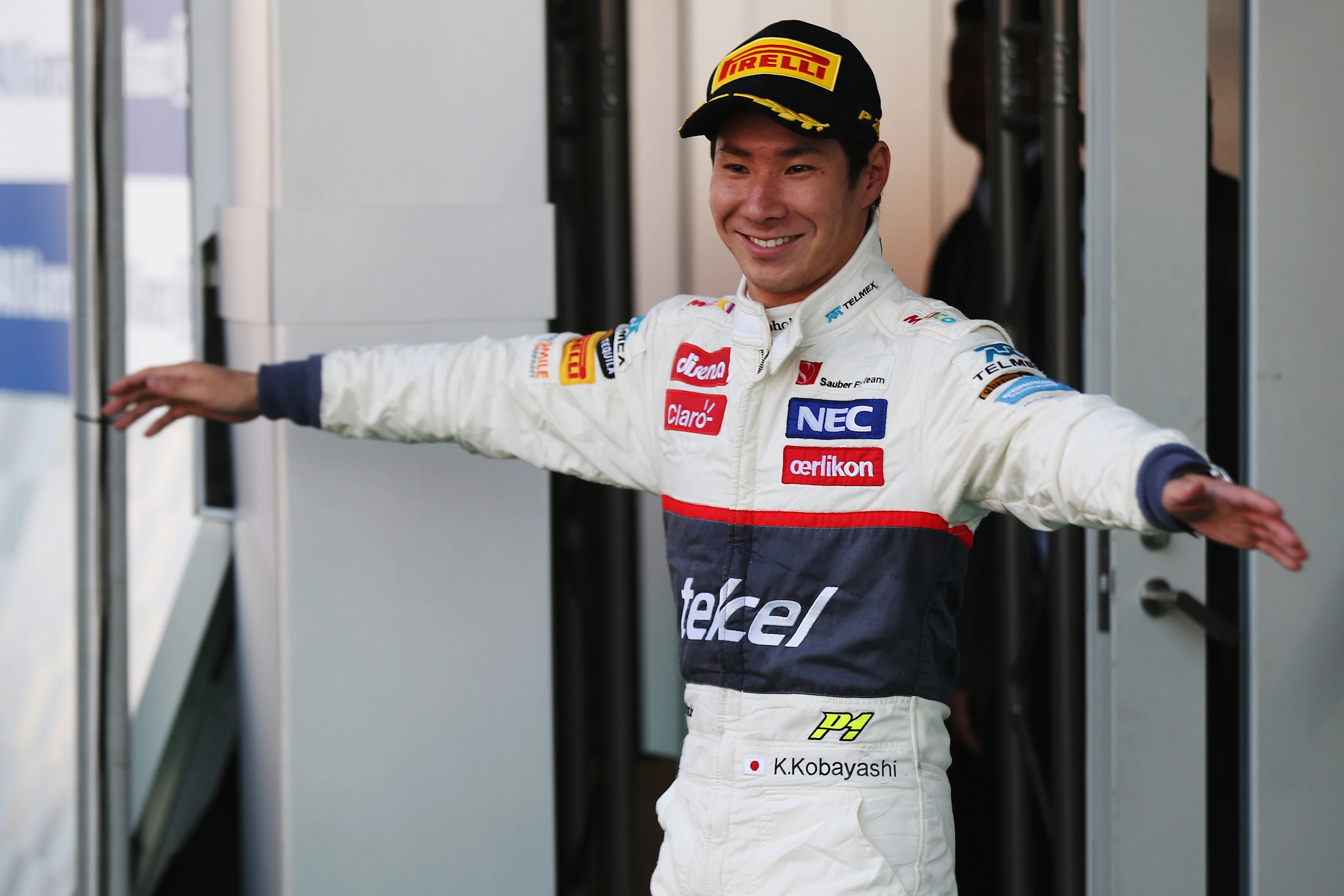 SUZUKA, JAPAN - OCTOBER 07: Kamui Kobayashi of Japan and Sauber F1 celebrates on the podium after