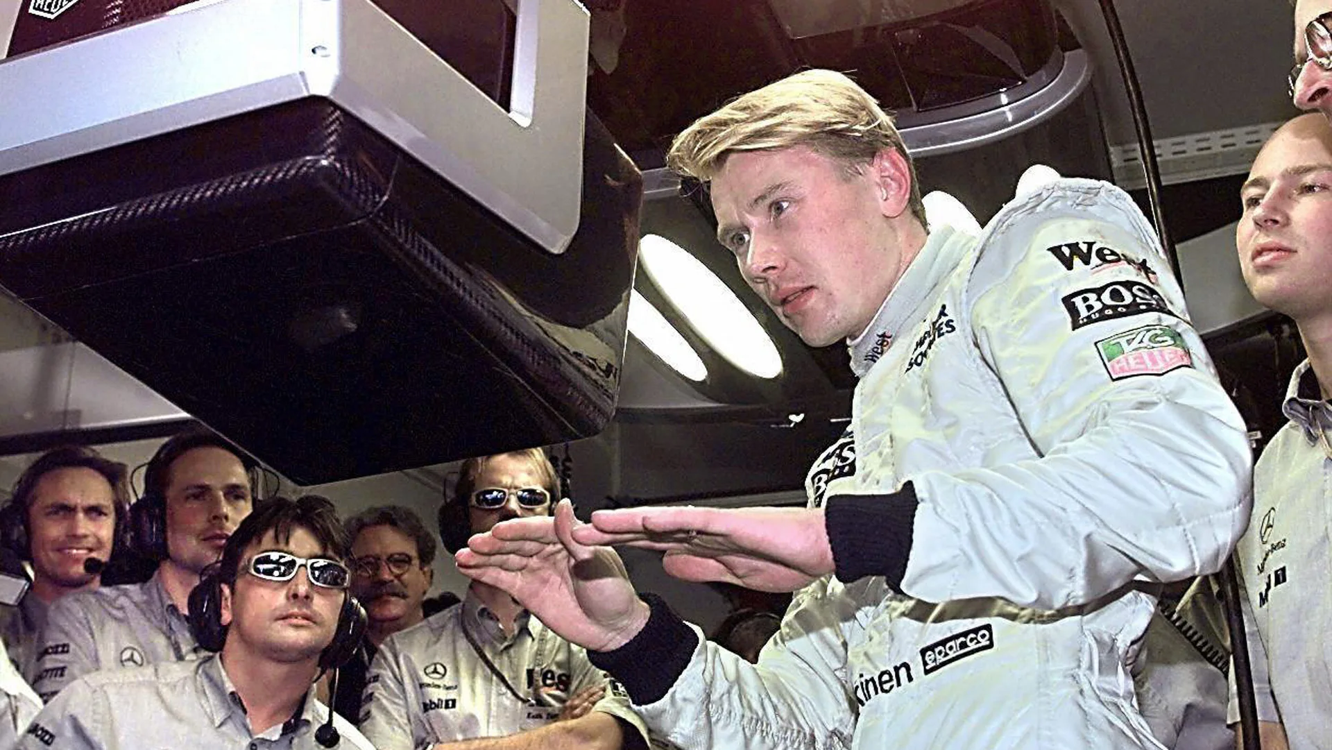 Finland's McLaren-Mercedes driver Mika Hakkinen makes sign to the crew that the qualifying session