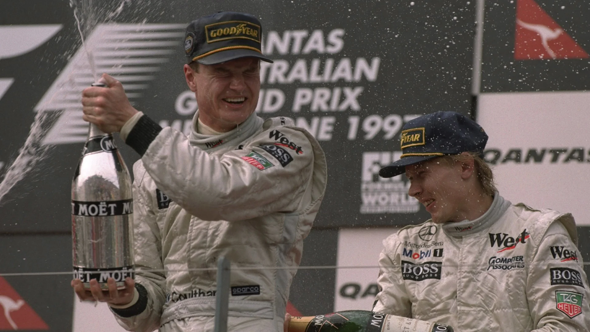 9 Mar 1997: David Coulthard (left) of Great Britain and Mika Hakkinen of Finland enjoy the spoils