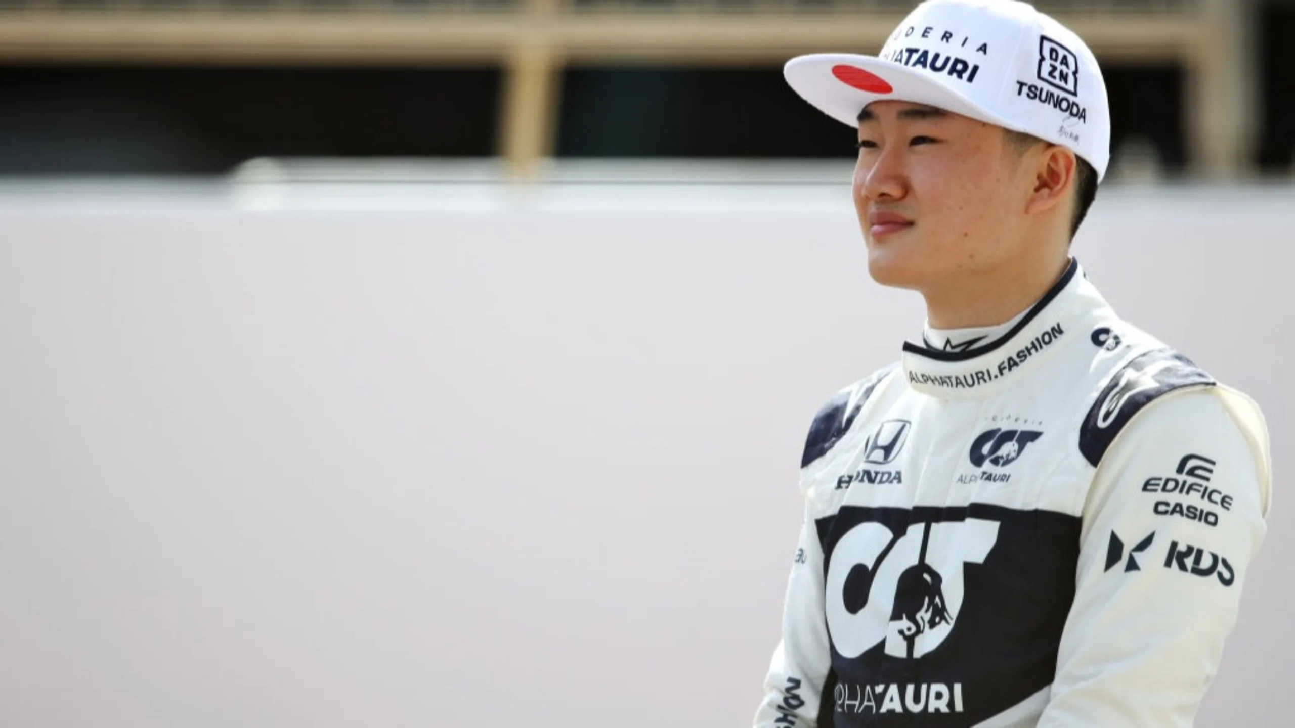 BAHRAIN, BAHRAIN - MARCH 12: Yuki Tsunoda of Japan and Scuderia AlphaTauri looks on from the grid