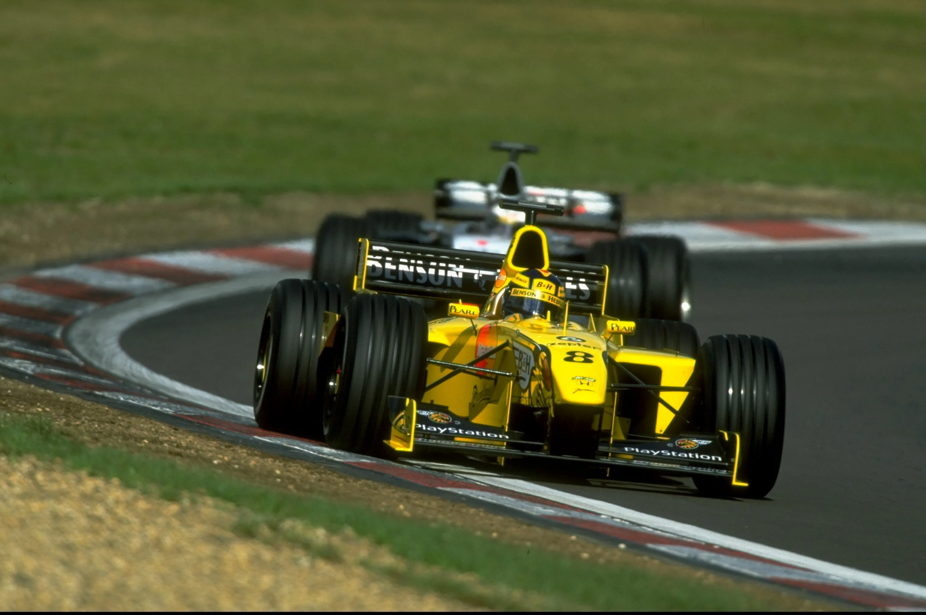 26 Sep 1999: Heinz Harald Frentzen of Germany races the Jordan ahead of Mika Hakkinen of Mercedes