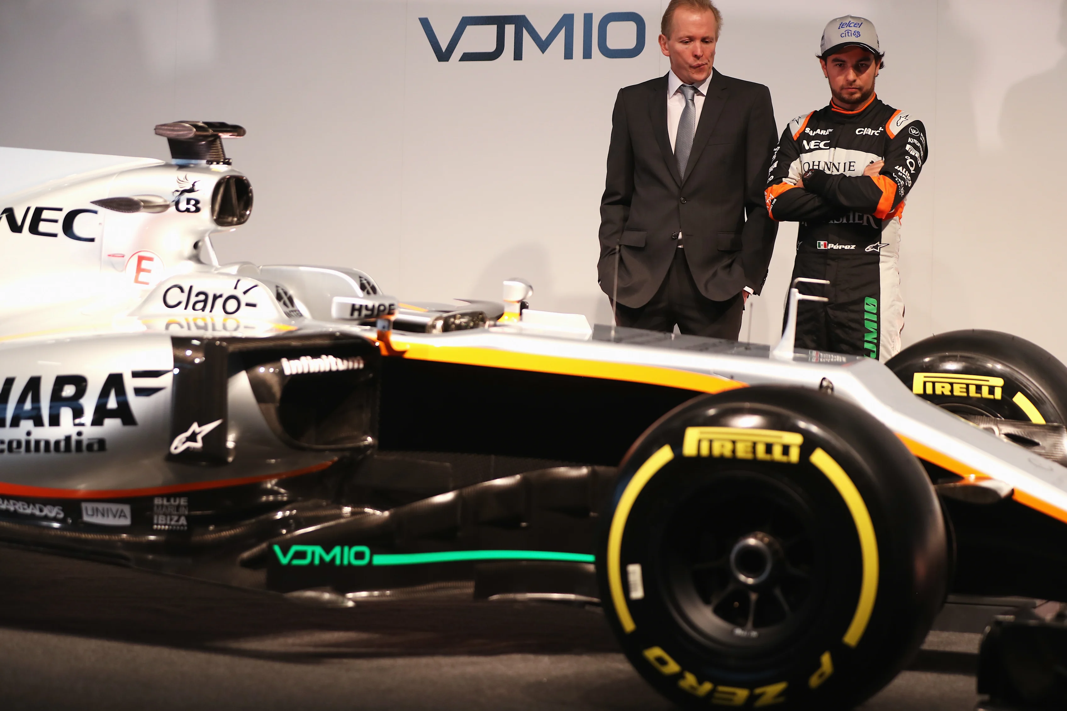 NORTHAMPTON, ENGLAND - FEBRUARY 22: Sergio Perez (R) of Mexico and Sahara Force India looks at the