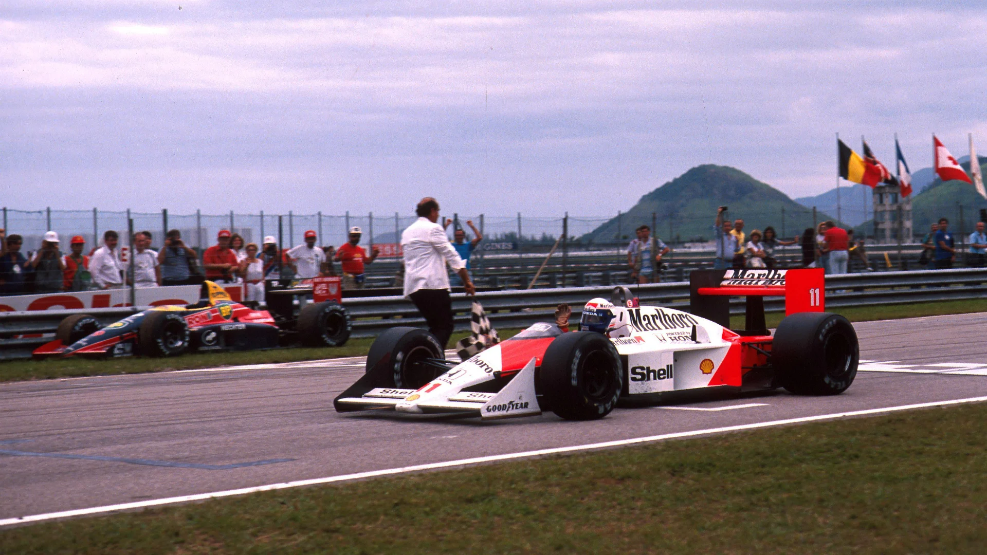 Alain Prost FRA McLaren MP44 Honda RA168-E takes the flag and the win Brazilian Grand Prix