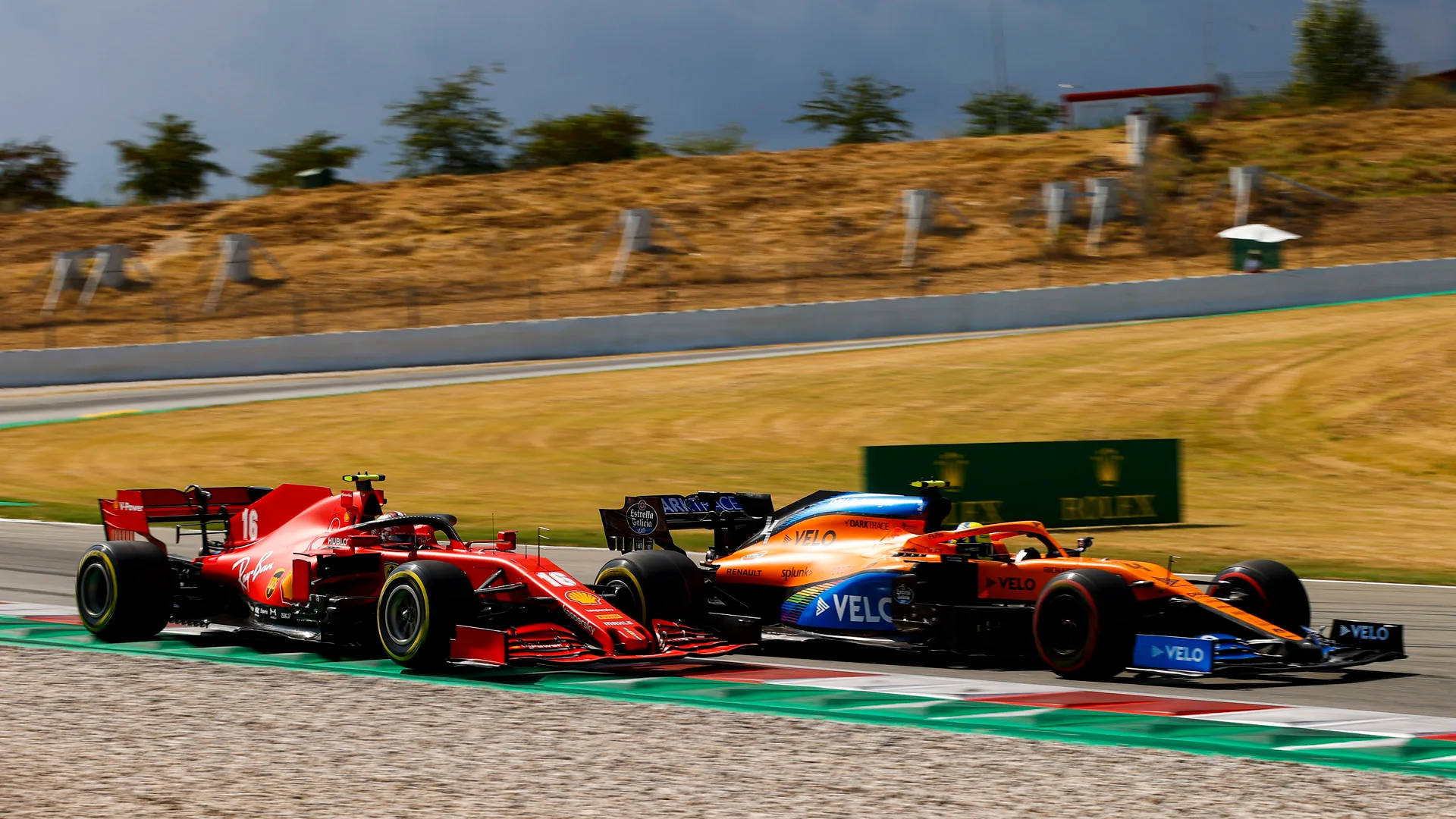 Lando Norris, McLaren MCL35, battles with Charles Leclerc, Ferrari