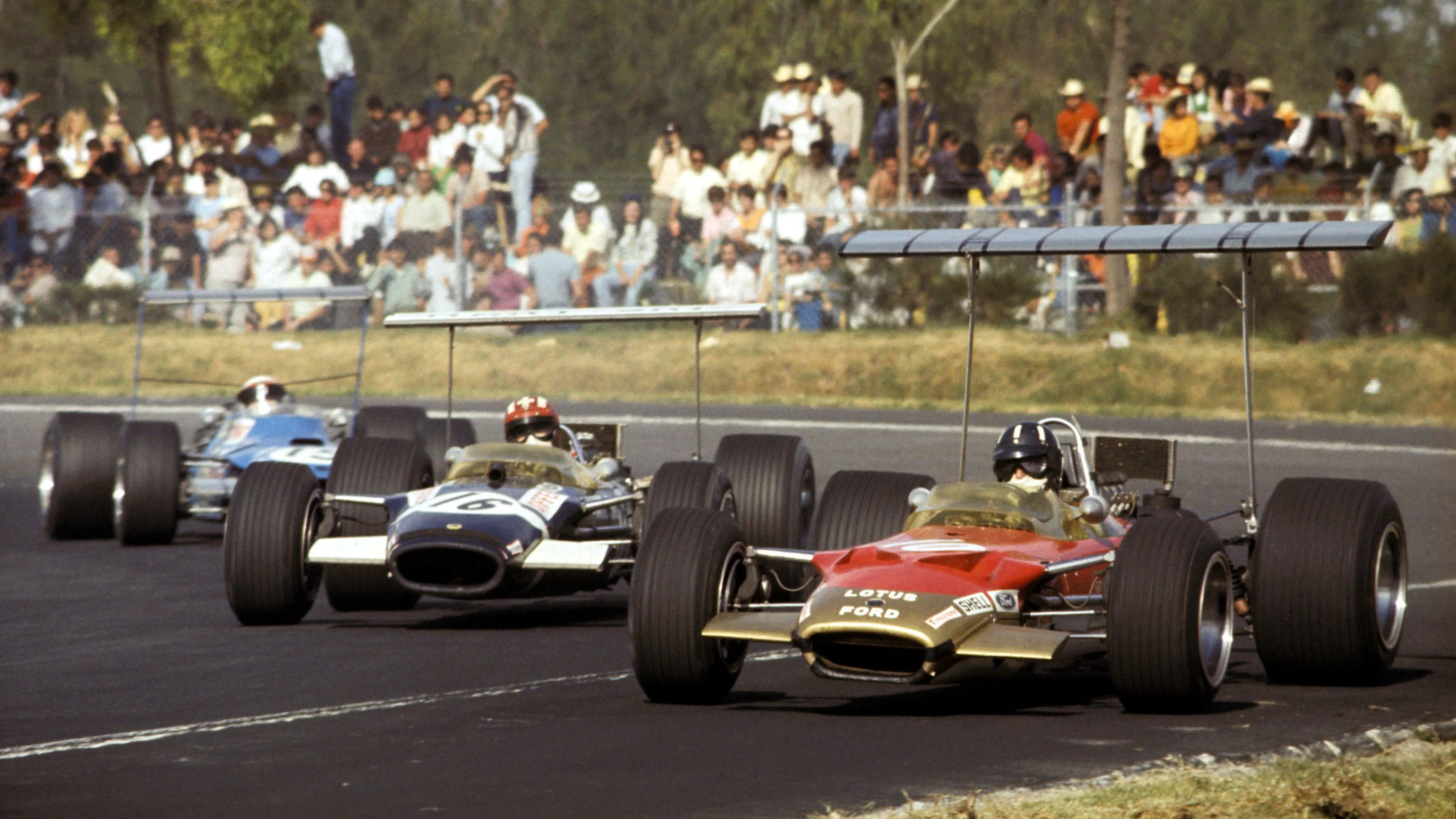 Graham Hill (GBR) Lotus Cosworth 49B, leads pole position man Jo Siffert (SUI) in a similar Rob