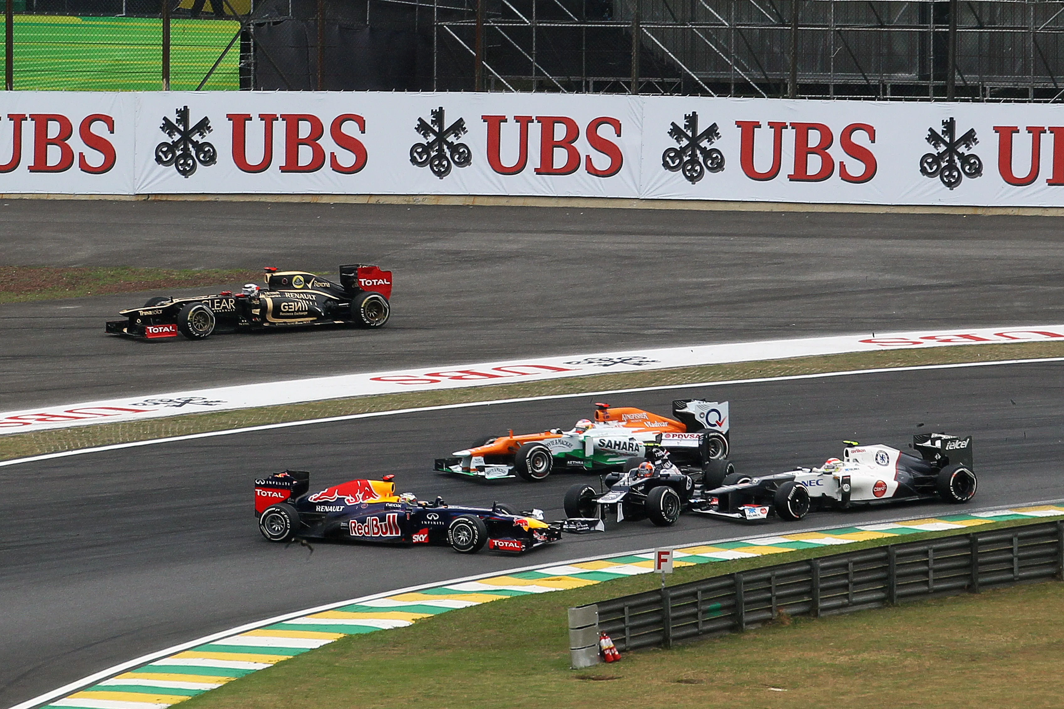 Bruno Senna (BRA) Williams FW34 hits Sebastian Vettel (GER) Red Bull Racing RB8 and Sergio Perez