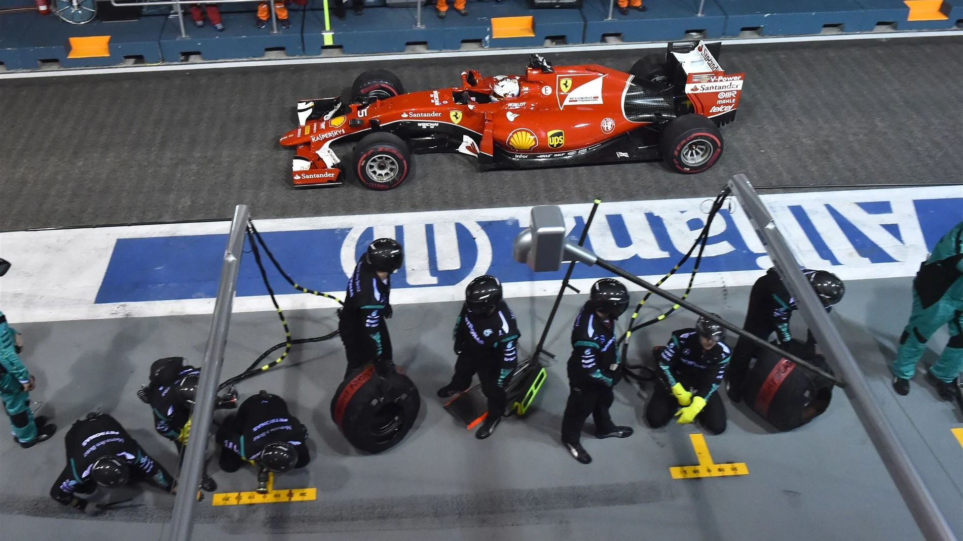Sebastian Vettel (GER) Ferrari SF15-T passes Mercedes AMG F1 pit crew at Formula One World