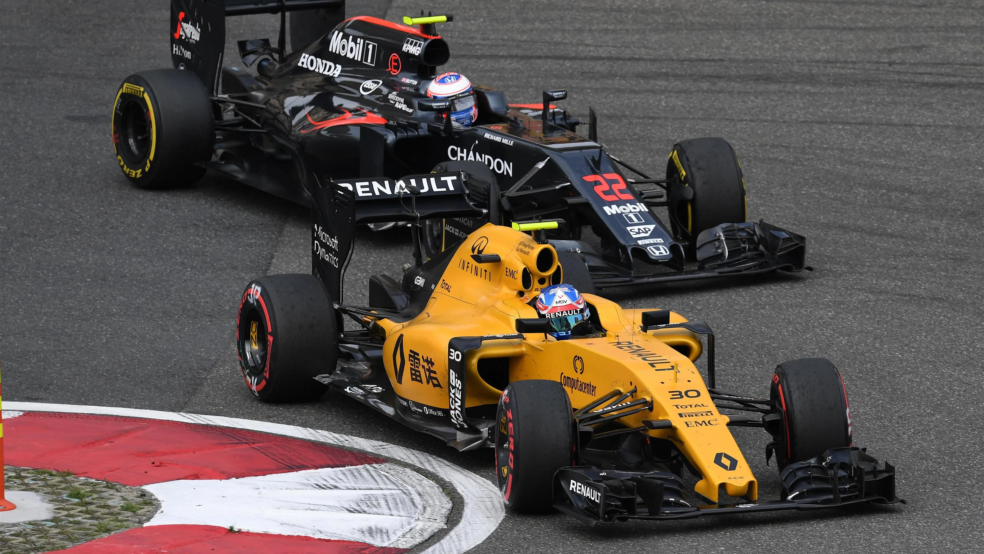 Jolyon Palmer (GBR) Renault Sport F1 Team RS16 and Jenson Button (GBR) McLaren MP4-31 at Formula