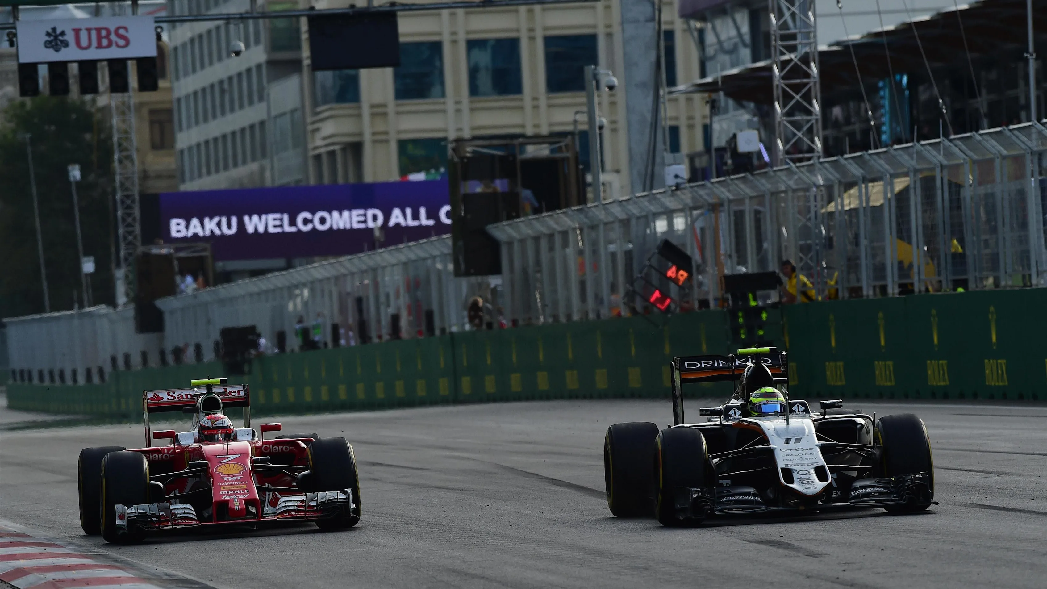 Kimi Raikkonen (FIN) Ferrari SF16-H and Sergio Perez (MEX) Force India VJM09 at Formula One World
