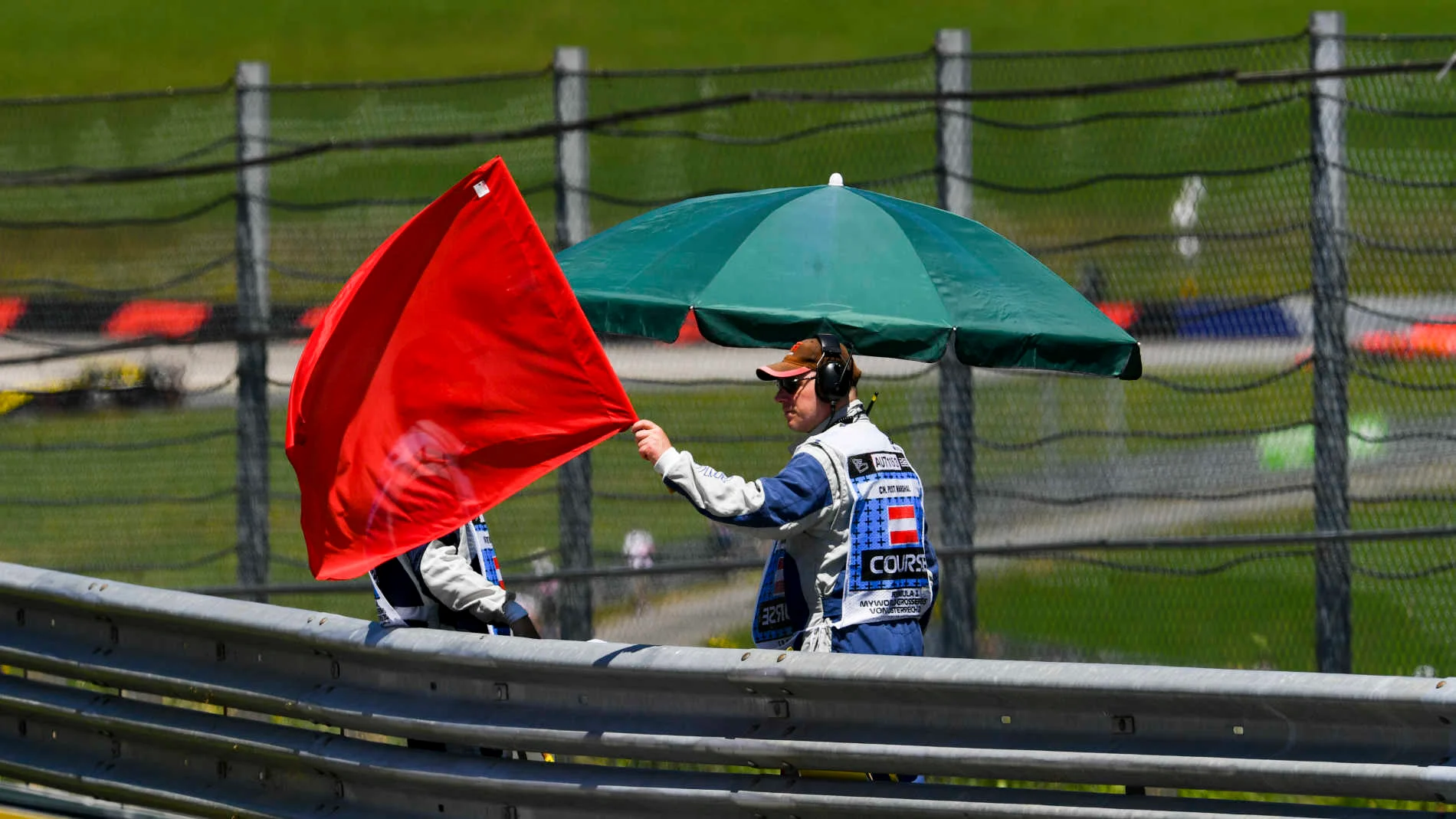 RED BULL RING, AUSTRIA - JUNE 28: Marshal waves Red Flag during the Austrian GP at Red Bull Ring on
