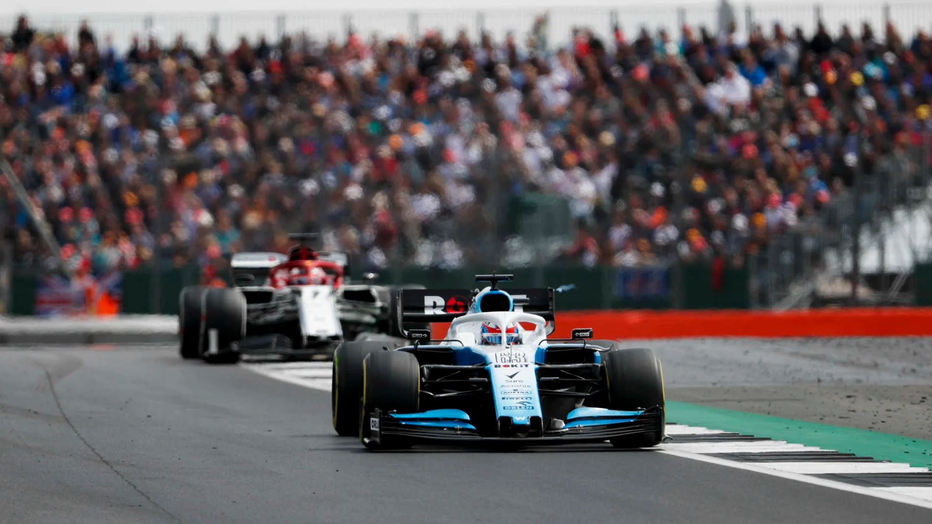 SILVERSTONE, UNITED KINGDOM - JULY 14: George Russell, Williams Racing FW42, leads Kimi Raikkonen,