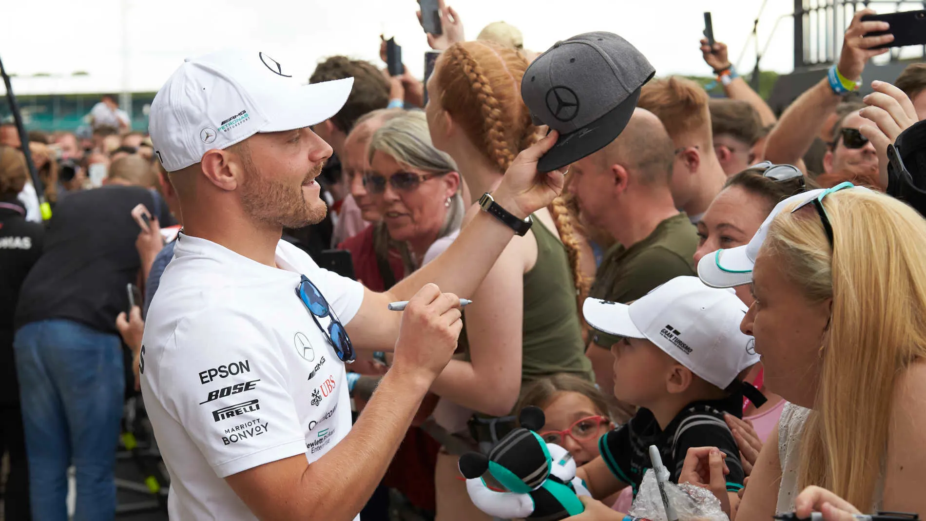 SILVERSTONE, UNITED KINGDOM - JULY 11: Valtteri Bottas, Mercedes AMG F1, signs autographs for fans